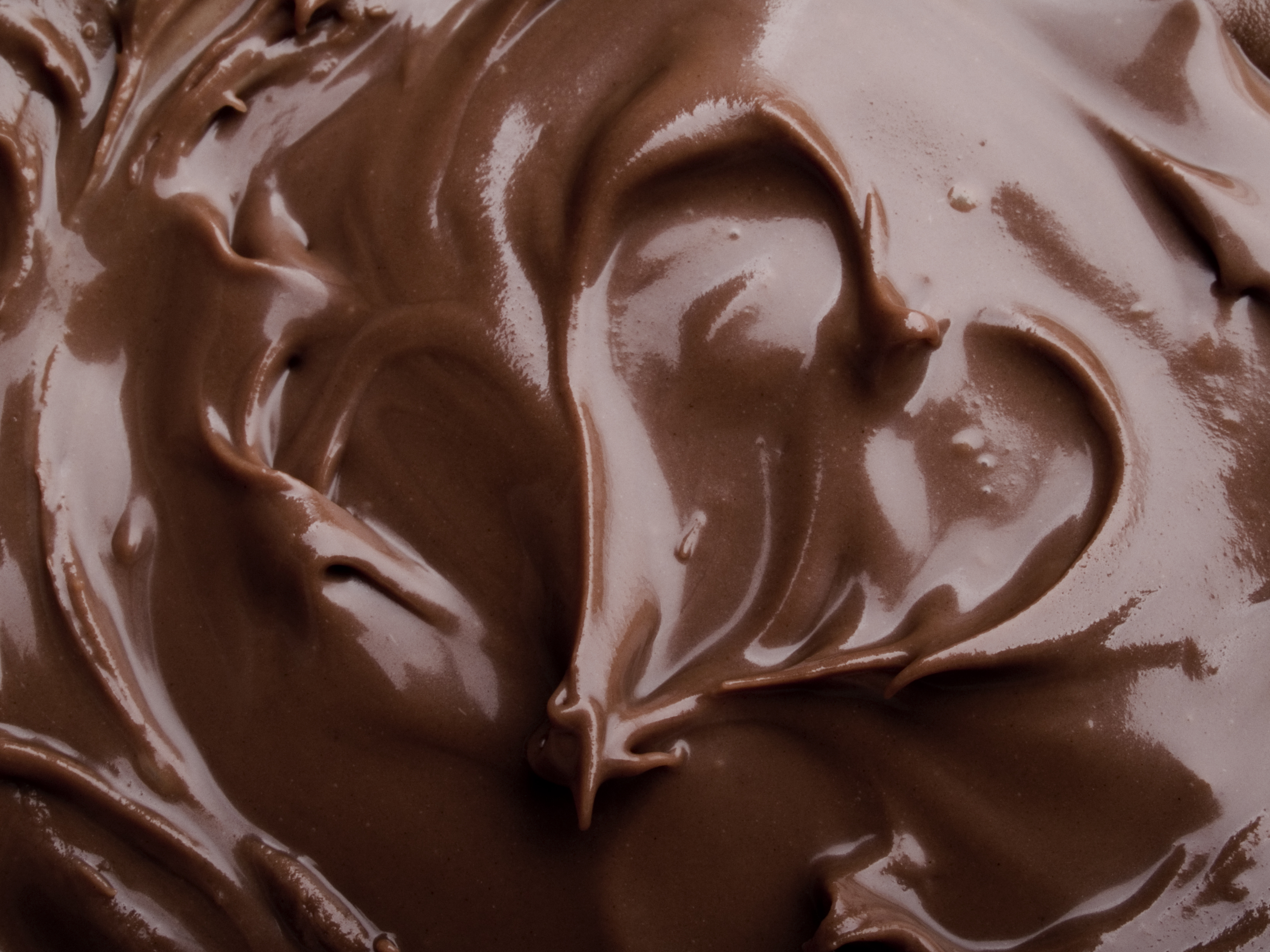 Melted chocolate with a heart shape in it.