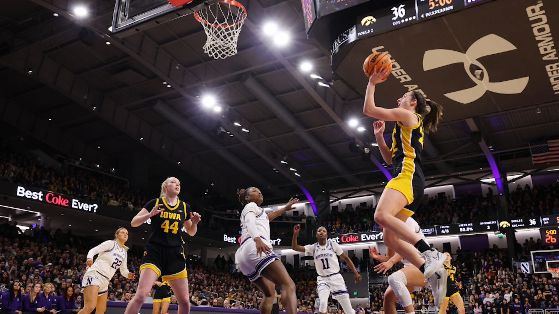 Caitlin Clark #22 of the Iowa Hawkeyes scores her 3,403 career point, passing Kelsey Mitchell for second in Division I NCAA women's basketball history, during the second quarter against the Northwestern Wildcats at Welsh-Ryan Arena on January 31, 2024 in Evanston, Illinois.