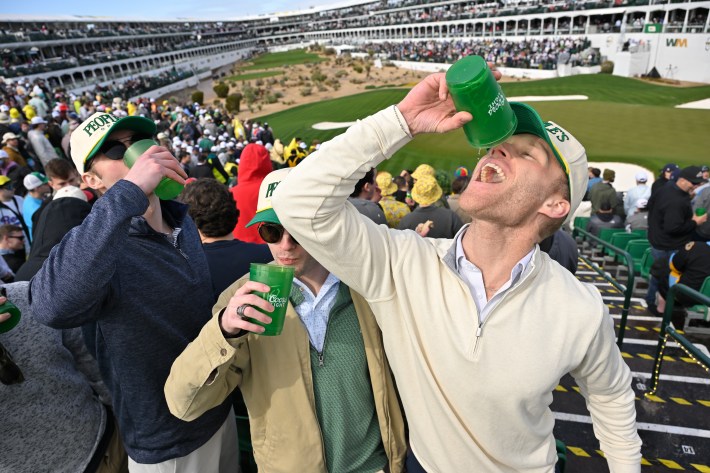 SCOTTSDALE, ARIZONA - FEBRUARY 09: Fans drink beer together in the stands on the 16th hole during the continuation of the first round of WM Phoenix Open at TPC Scottsdale (Stadium Course) on February 9, 2024 in Scottsdale, Arizona.