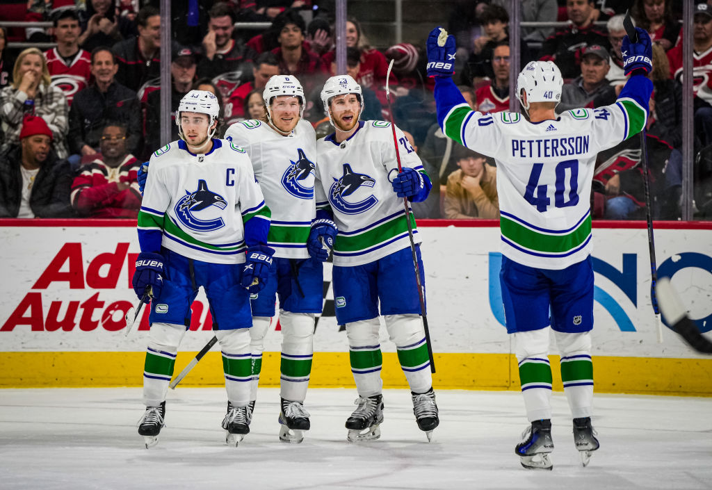 Elias Lindholm celebrates with his teammates after a goal