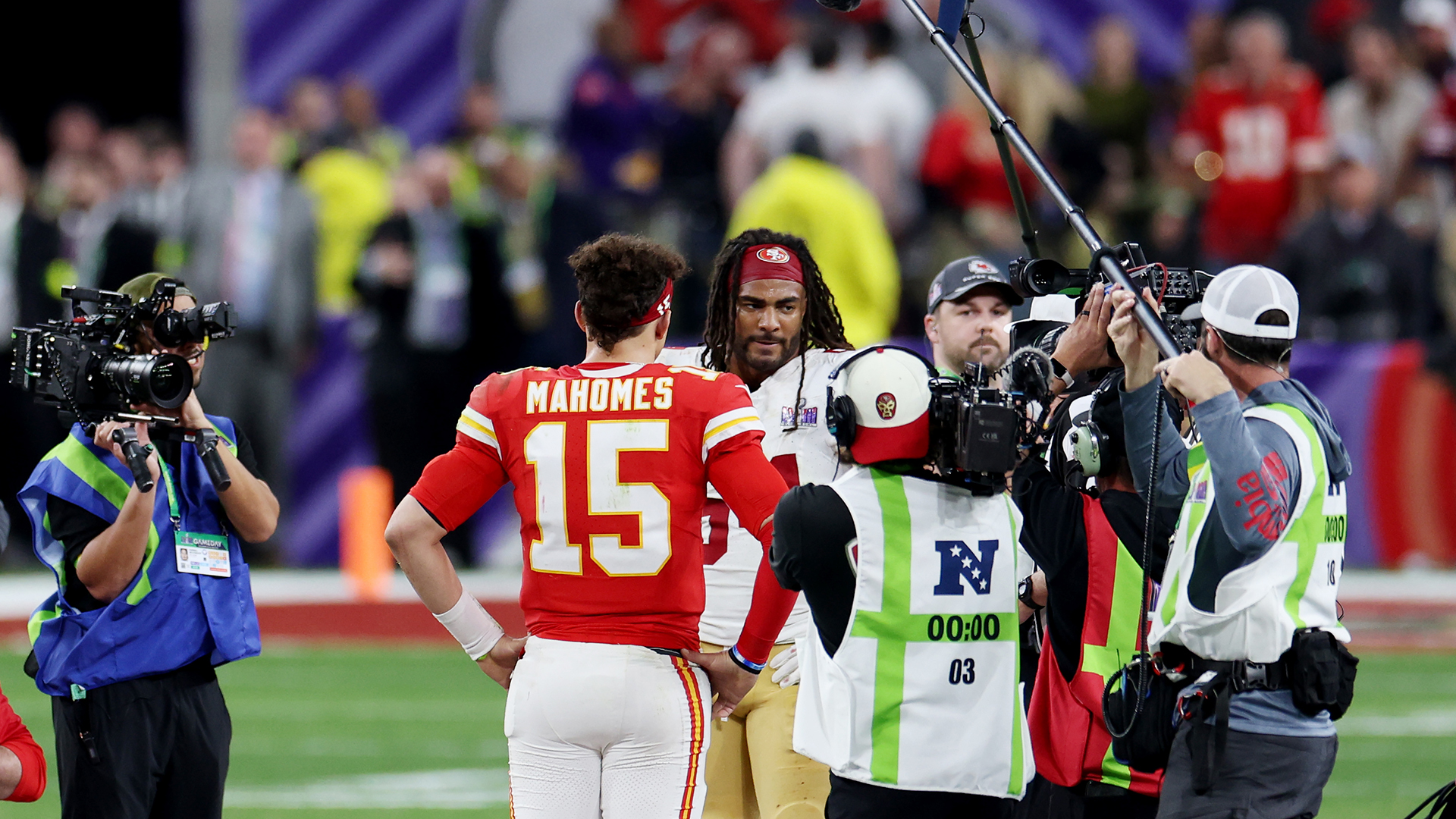 Fred Warner #54 of the San Francisco 49ers and Patrick Mahomes #15 of the Kansas City Chiefs meet at mid-field for the overtime coin toss during Super Bowl LVIII at Allegiant Stadium on February 11, 2024 in Las Vegas, Nevada.