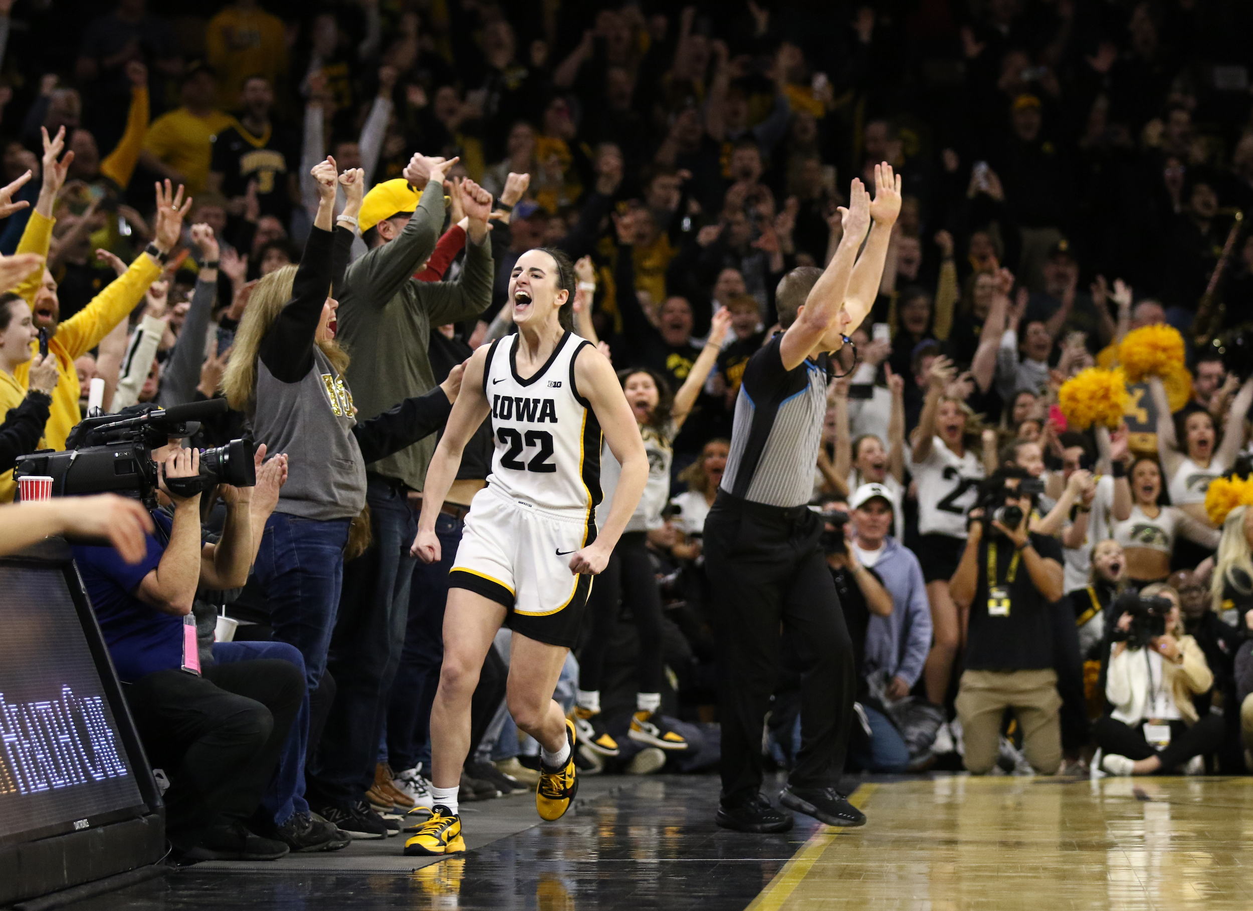Guard Caitlin Clark #22 of the Iowa Hawkeyes celebrates after breaking the NCAA women's all-time scoring record during the first half against the Michigan Wolverines at Carver-Hawkeye Arena on February 15, 2024 in Iowa City, Iowa.
