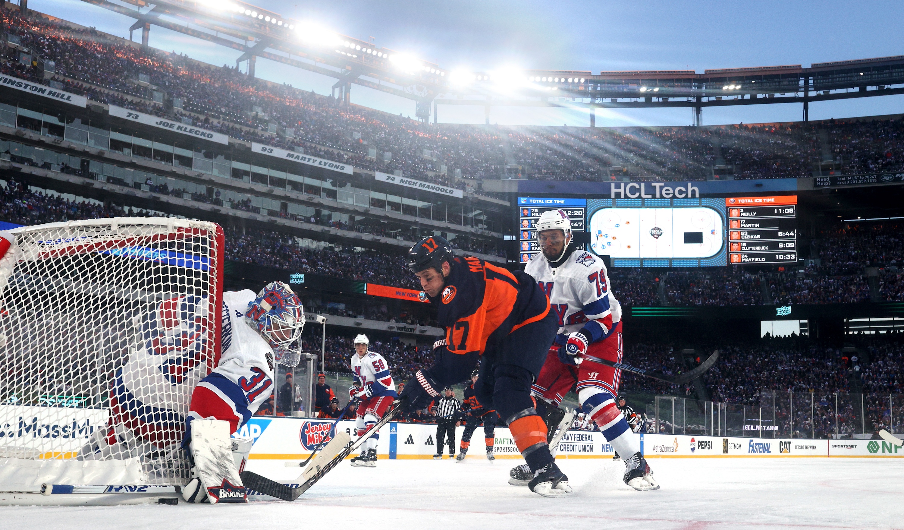 EAST RUTHERFORD, NEW JERSEY - FEBRUARY 18: Goaltender Igor Shesterkin #31 of the New York Rangers makes a save on a shot attempt by Matt Martin #17 of the New York Islanders during the first period of the 2024 Navy Federal Credit Union Stadium Series game between the New York Rangers and the New York Islanders at MetLife Stadium on February 18, 2024 in East Rutherford, New Jersey. (Photo by Dave Sandford/NHLI via Getty Images)