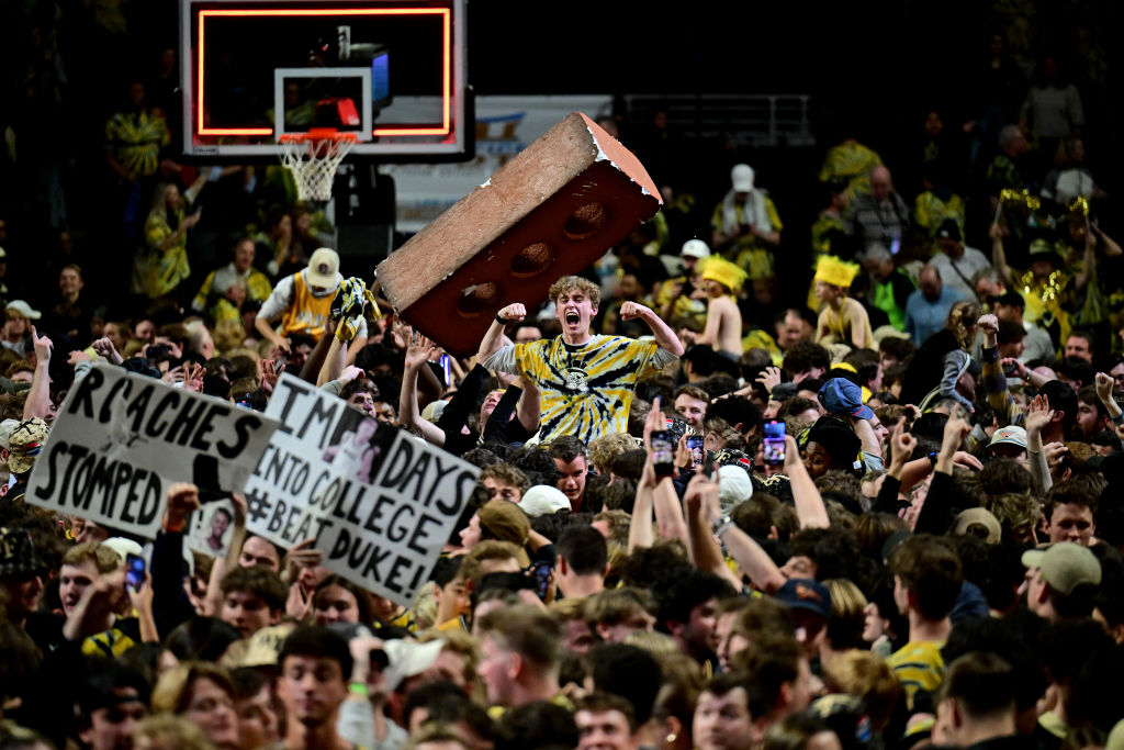 Wake Forest basketball fans packed together and celebrating after storming the court following their 83-79 upset victory over Duke.