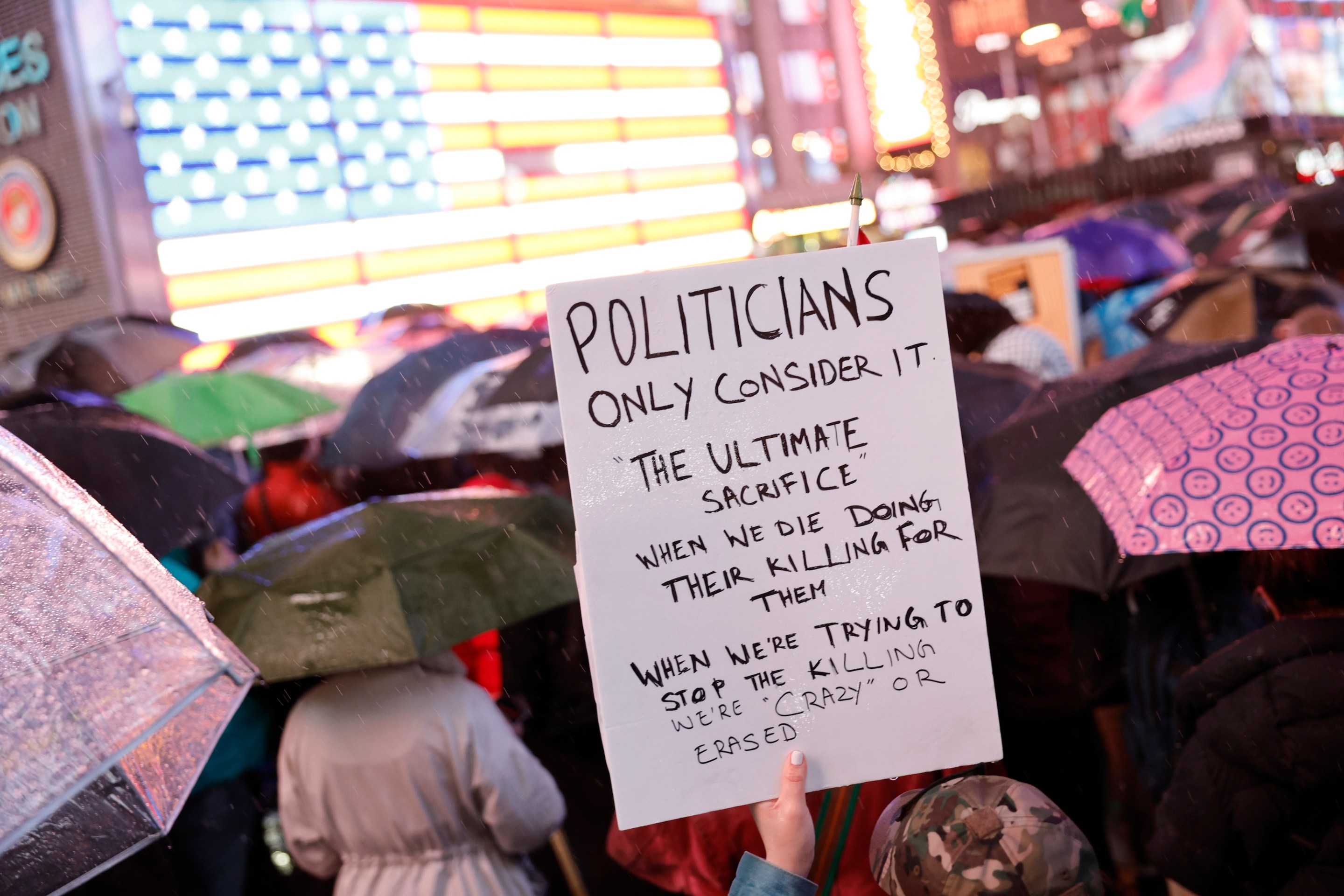 NEW YORK, NEW YORK - FEBRUARY 27: A person holds a sign during a vigil for U.S. Airman Aaron Bushnell at the US Army Recruiting Office in Times Square on February 27, 2024 in New York City. Bushnell died after setting himself on fire outside the Israeli Embassy in Washington, DC on Sunday. In a video that was posted to a social media account showing the act, he stated that would “no longer be complicit in genocide," before pouring an unknown liquid over himself and igniting it while yelling “Free Palestine” repeatedly. (Photo by Michael M. Santiago/Getty Images)
