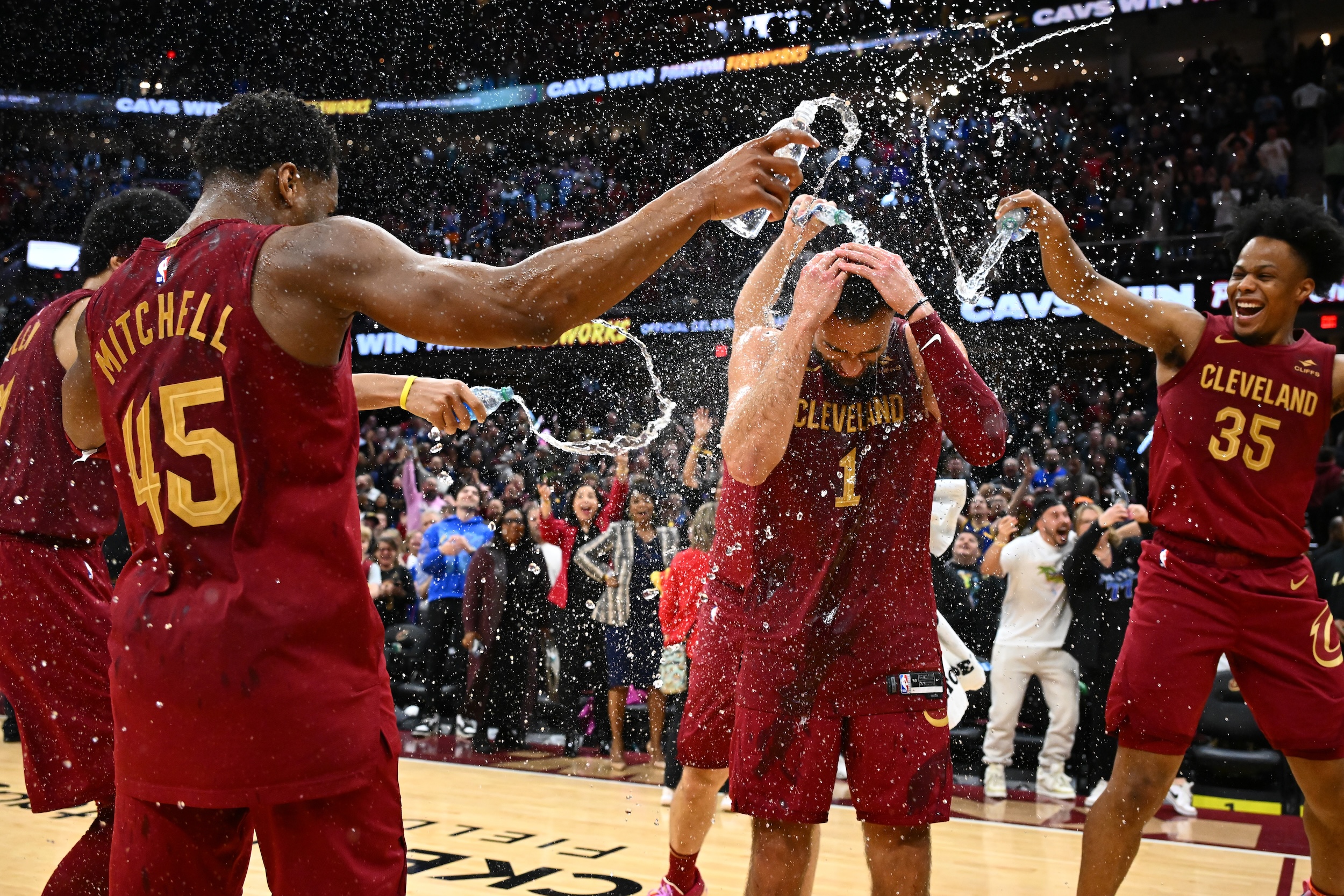 Teammates fling water onto Max Strus following his game-winner.