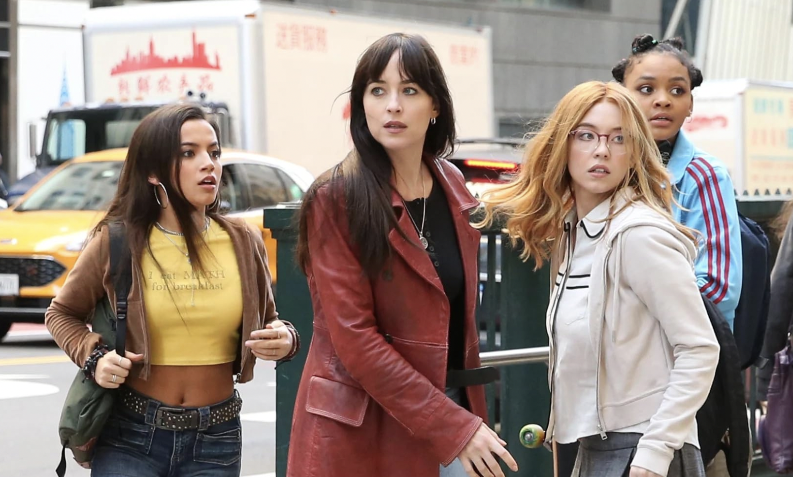 dakota johnson in a red leather blazer looking confused