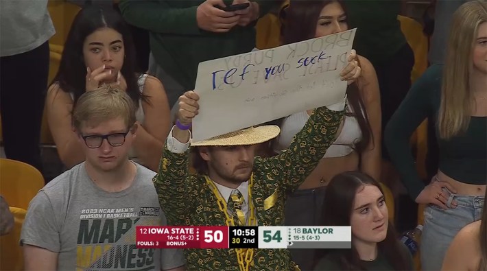 Baylor fan with hastily-scribbled "ref, you suck" on back of his sign that says "BROCK PURDY PLEASE SAVE US" on the other side