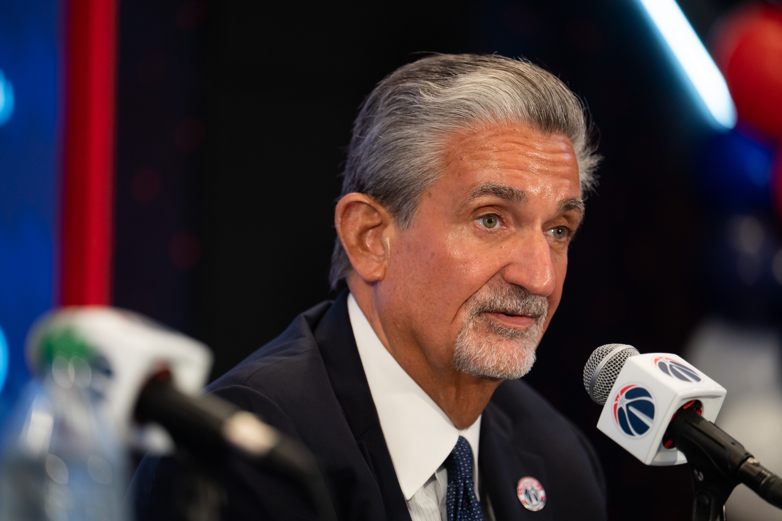 Ted Leonsis talks into a Wizards-branded microphone.