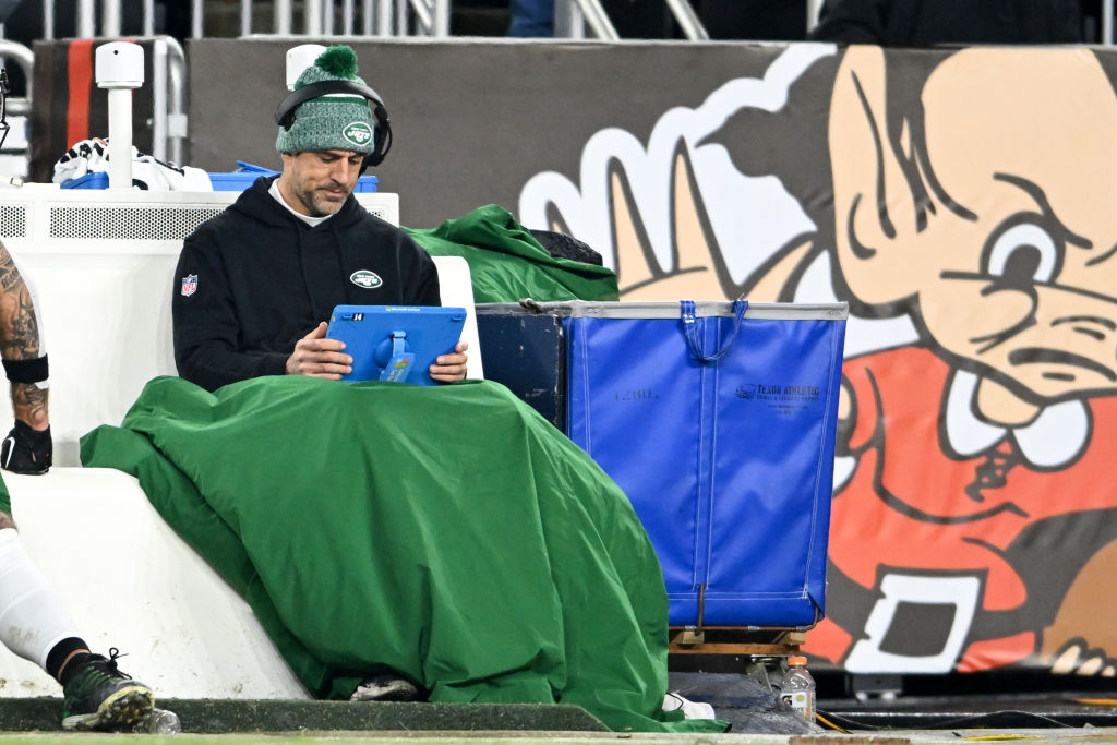 Aaron Rodgers #8 of the New York Jets looks at a Microsoft Surface tablet during the second half against the Cleveland Browns at Cleveland Browns Stadium on December 28, 2023 in Cleveland, Ohio.