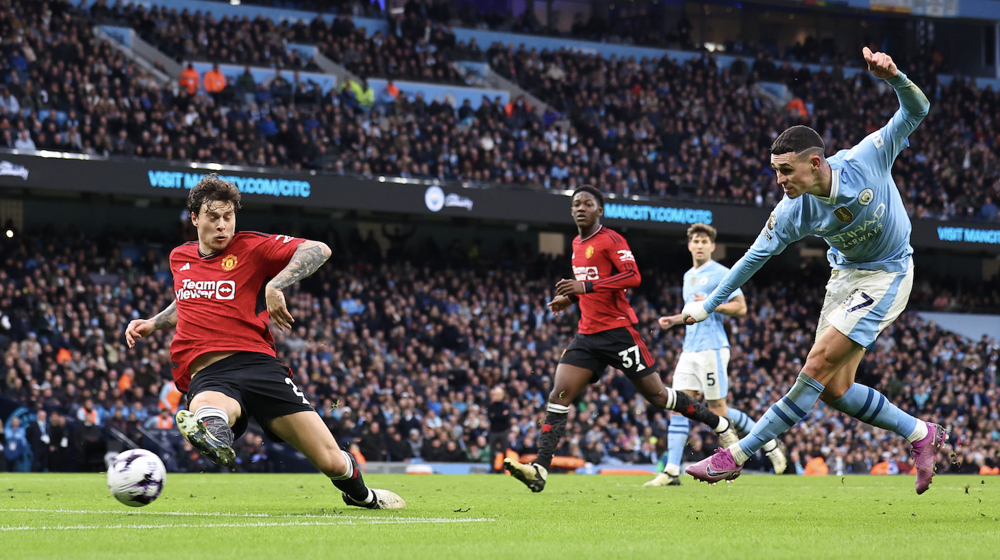 Phil Foden of Manchester City scores a goal to make it 2-1 during the Premier League match between Manchester City and Manchester United at Etihad Stadium on March 3, 2024 in Manchester, England.