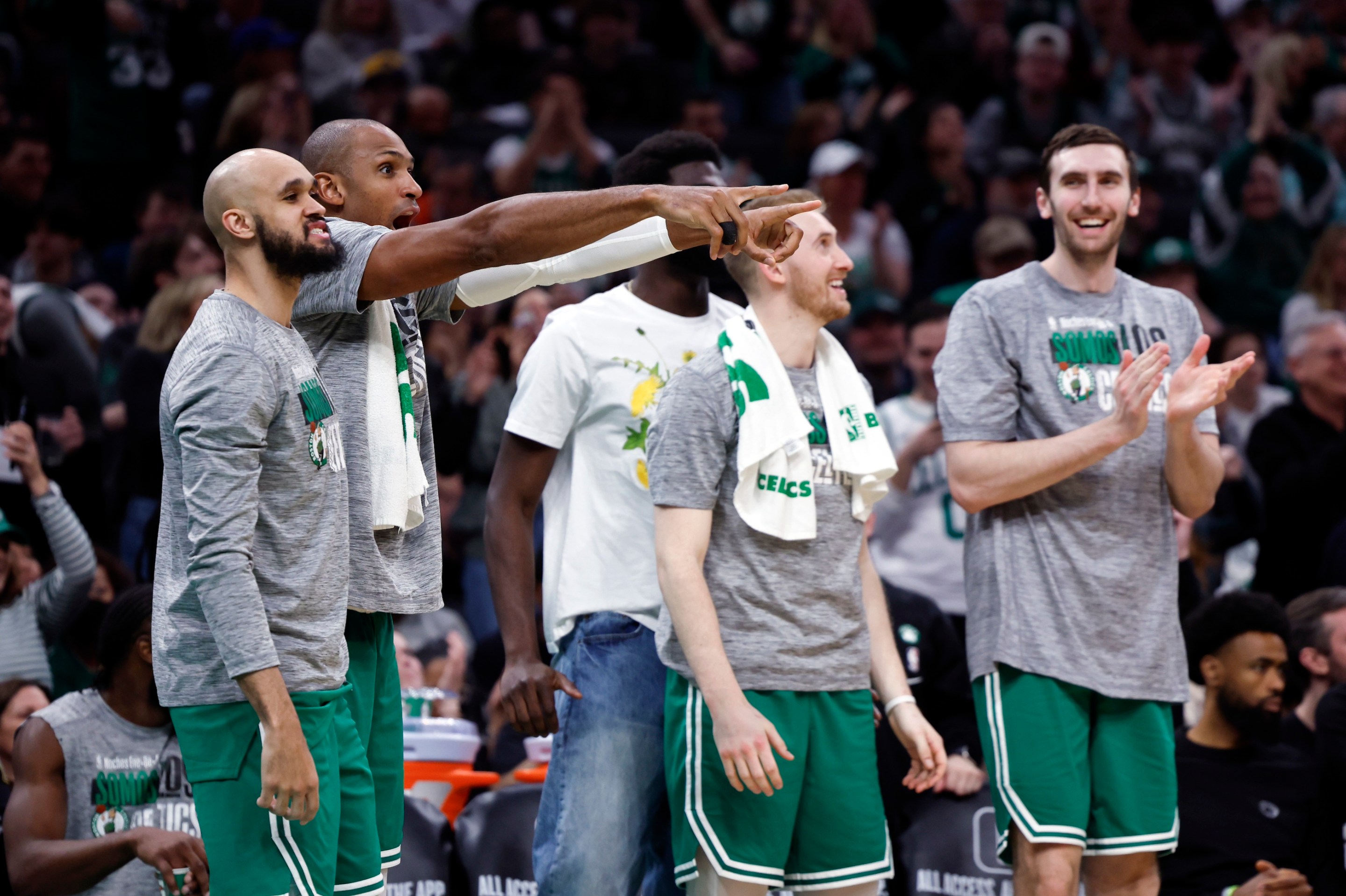Boston Celtics center Al Horford (second from left) and the bench react to a slam dunk by Boston Celtics guard Svi Mykhailiuk (not pictured) in the fourth quarter. The Celtics beat the Golden State Warriors, 140-88.