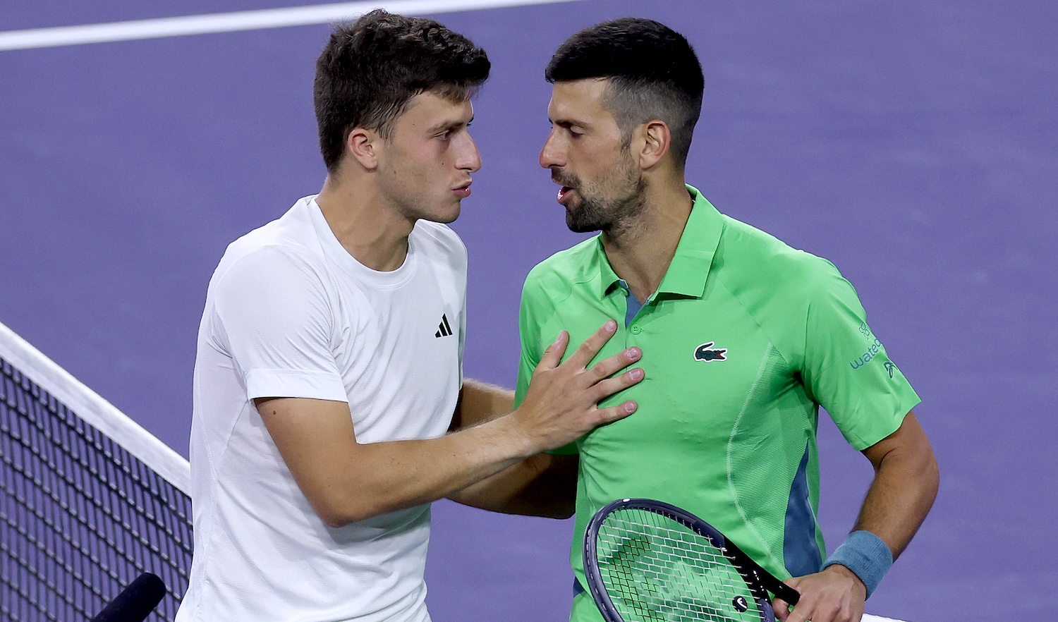 INDIAN WELLS, CALIFORNIA - MARCH 11: Luca Nardi of Italy is congratulated by Novak Djokovic of Serbia after their match during the BNP Paribas Open at Indian Wells Tennis Garden on March 11, 2024 in Indian Wells, California. (Photo by Matthew Stockman/Getty Images)