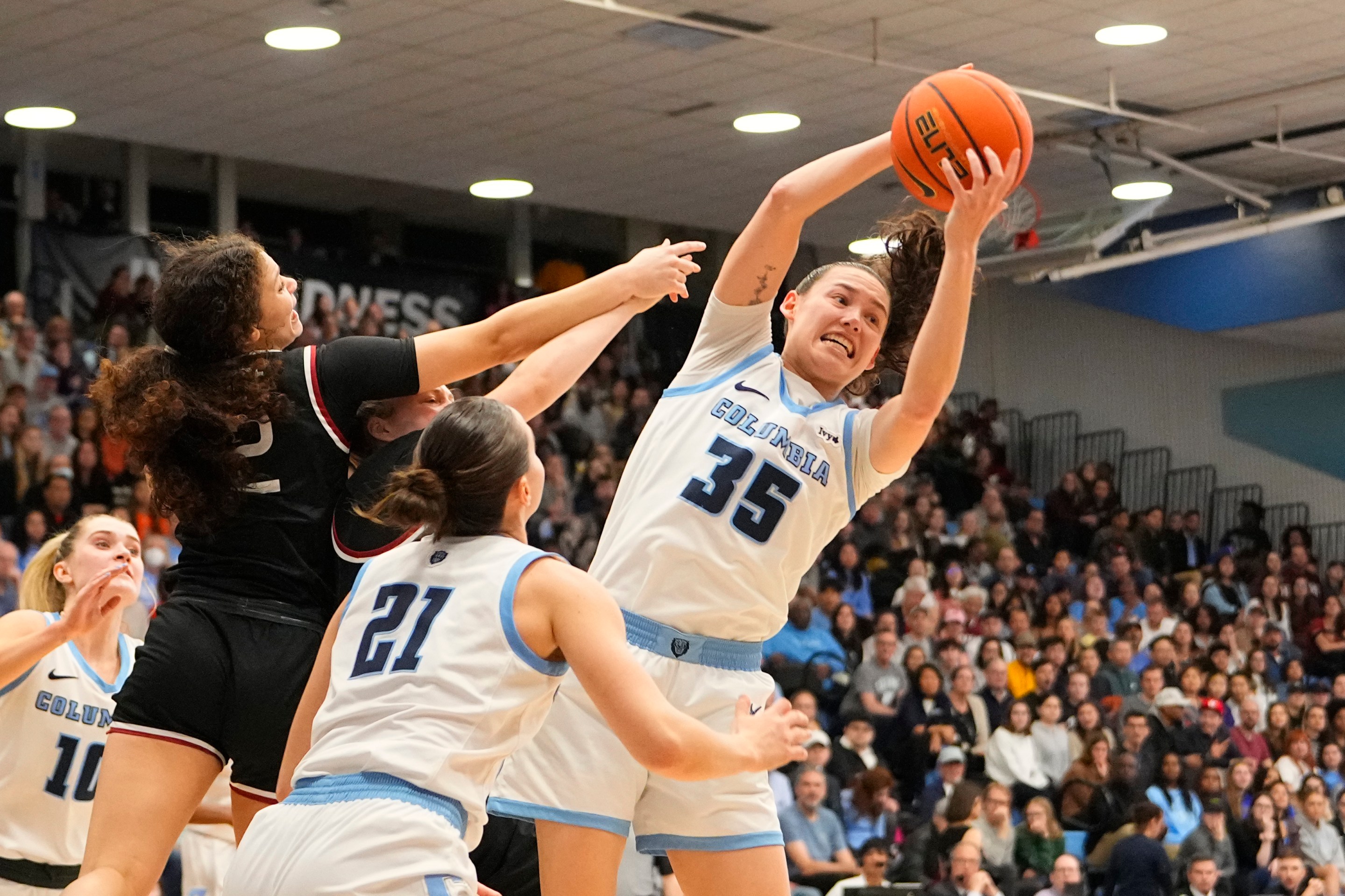 Columbia Lions Guard Abbey Hsu (35) grabs a rebound during the first half of the Women's Ivy League League Basketball Championship Semi-Final game between the Harvard Crimson and the Columbia Lions on March 15, 2024, at Levien Gymnasium in New York, NY.
