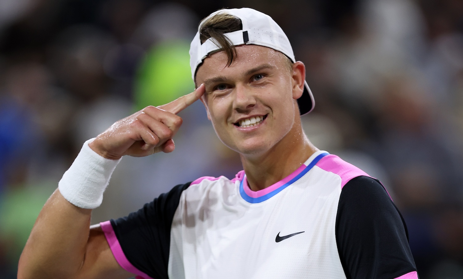 INDIAN WELLS, CALIFORNIA - MARCH 13: Holger Rune of Denmark celebrates to his team bench after his three set victory against Taylor Fritz of the United States in their fourth round match during the BNP Paribas Open at Indian Wells Tennis Garden on March 13, 2024 in Indian Wells, California. (Photo by Clive Brunskill/Getty Images)