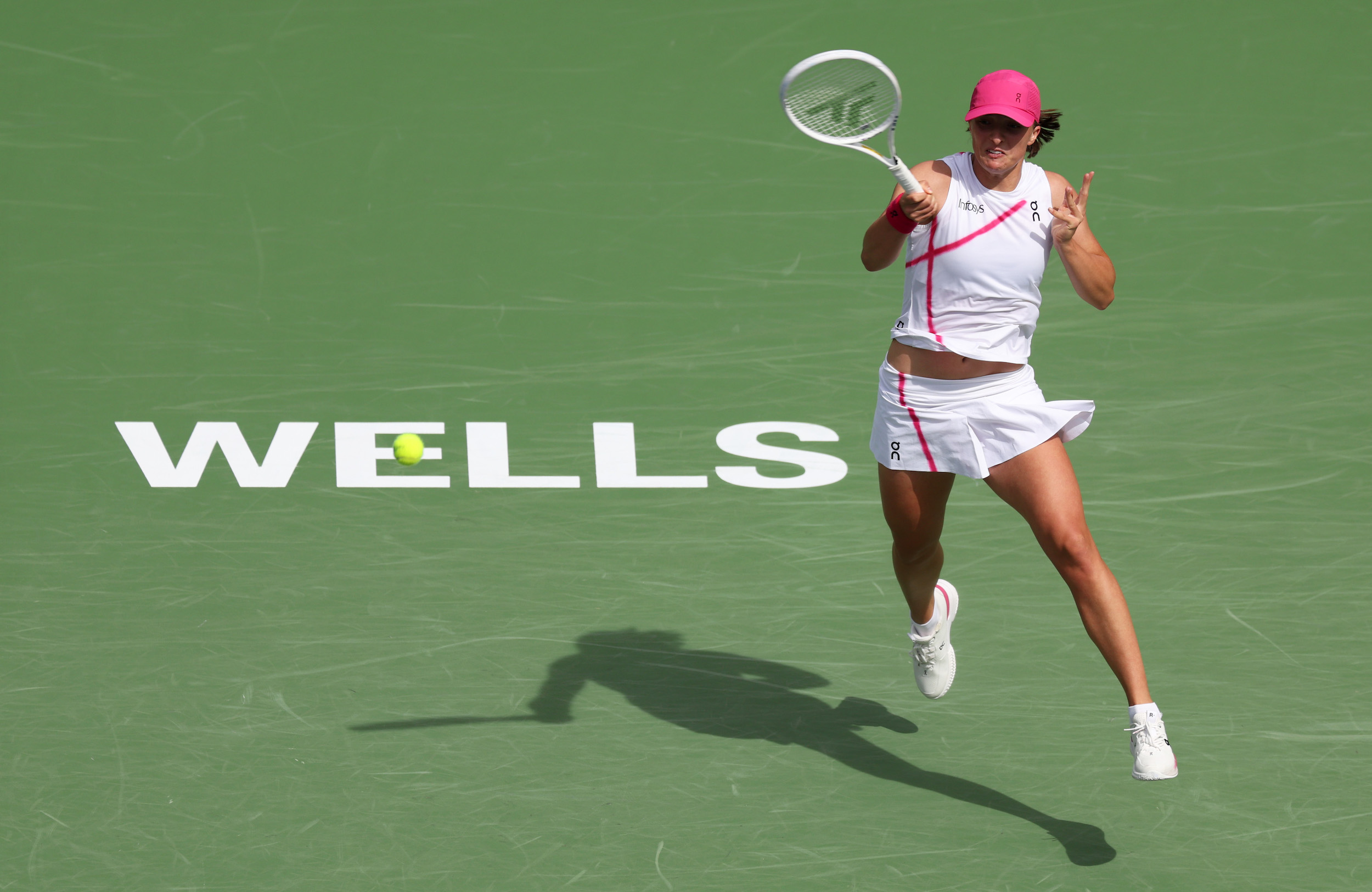 Iga Swiatek of Poland plays a forehand against Maria Sakkari of Greece in the Women's Final during the BNP Paribas Open at Indian Wells Tennis Garden on March 17, 2024 in Indian Wells, California