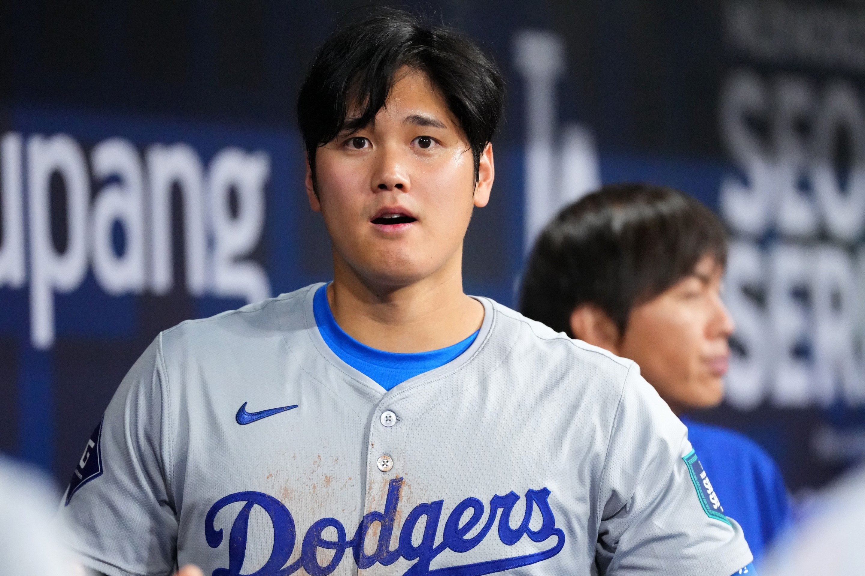 SEOUL, SOUTH KOREA - MARCH 20: Shohei Ohtani #17 of the Los Angeles Dodgers is seen while his interpreter Ippei Mizuhara is seen in the dugout during the 2024 Seoul Series game between Los Angeles Dodgers and San Diego Padres at Gocheok Sky Dome on March 20, 2024 in Seoul, South Korea. (Photo by Masterpress/Getty Images)