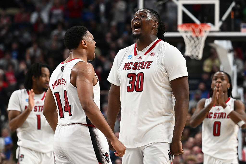 DJ Burns celebrates with Casey Morsell after a basket