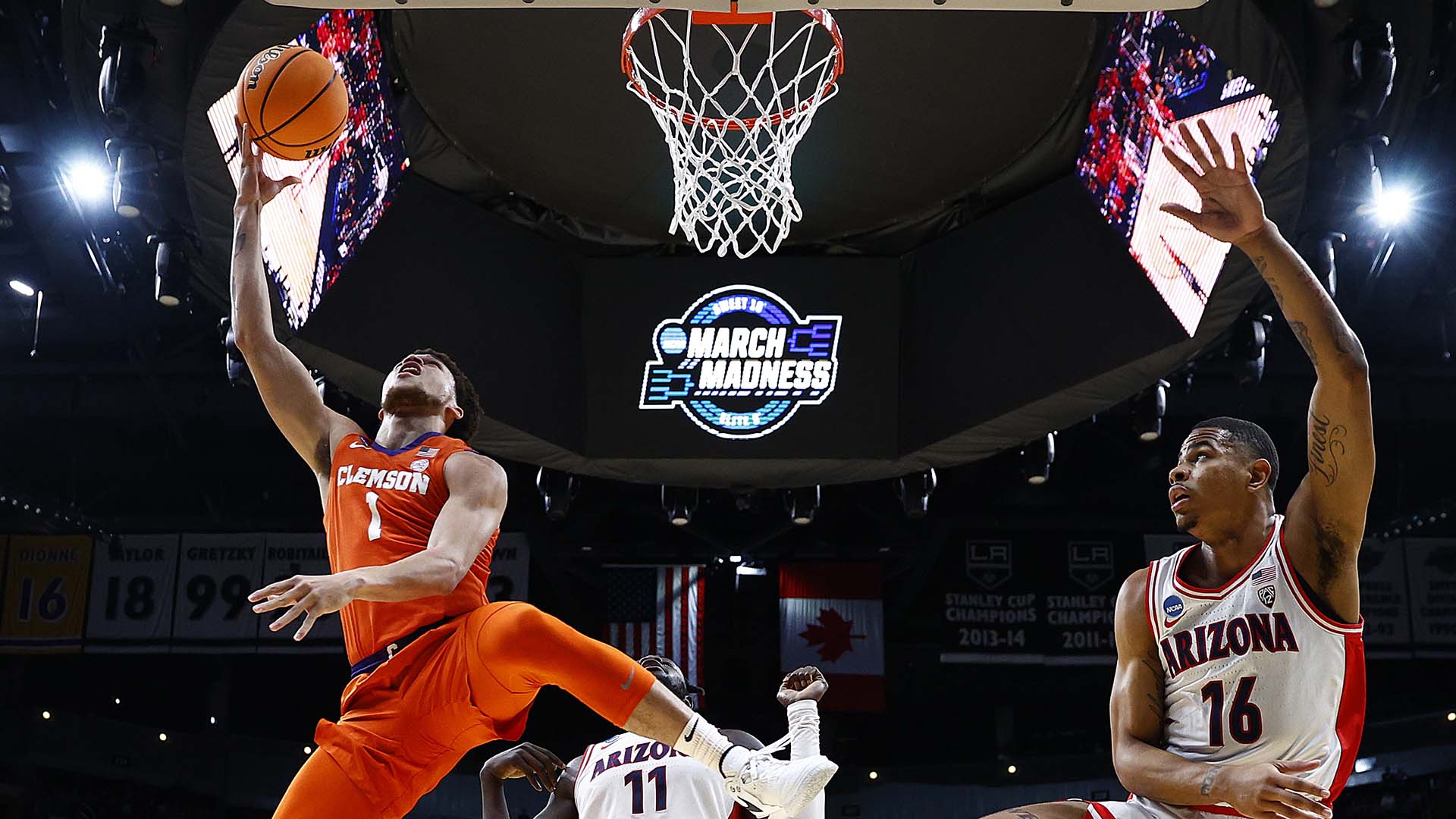 Chase Hunter #1 of the Clemson Tigers lays up against Keshad Johnson #16 of the Arizona Wildcats during the first half in the Sweet 16 round of the NCAA Men's Basketball Tournament at Crypto.com Arena on March 28, 2024 in Los Angeles, California