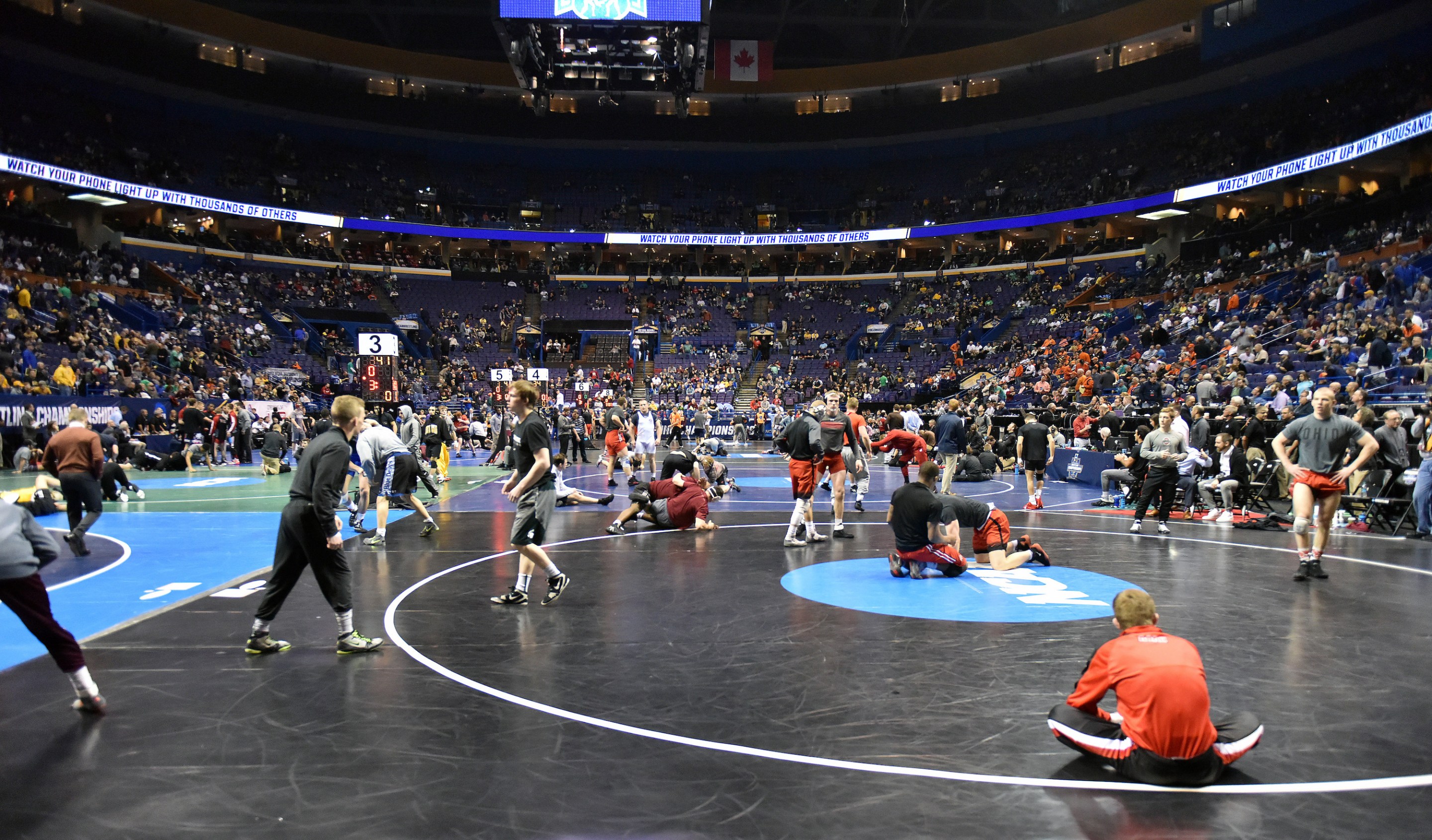Wrestlers warm up on the mat during the 2017 NCAA Wrestling Championships in St. Louis.