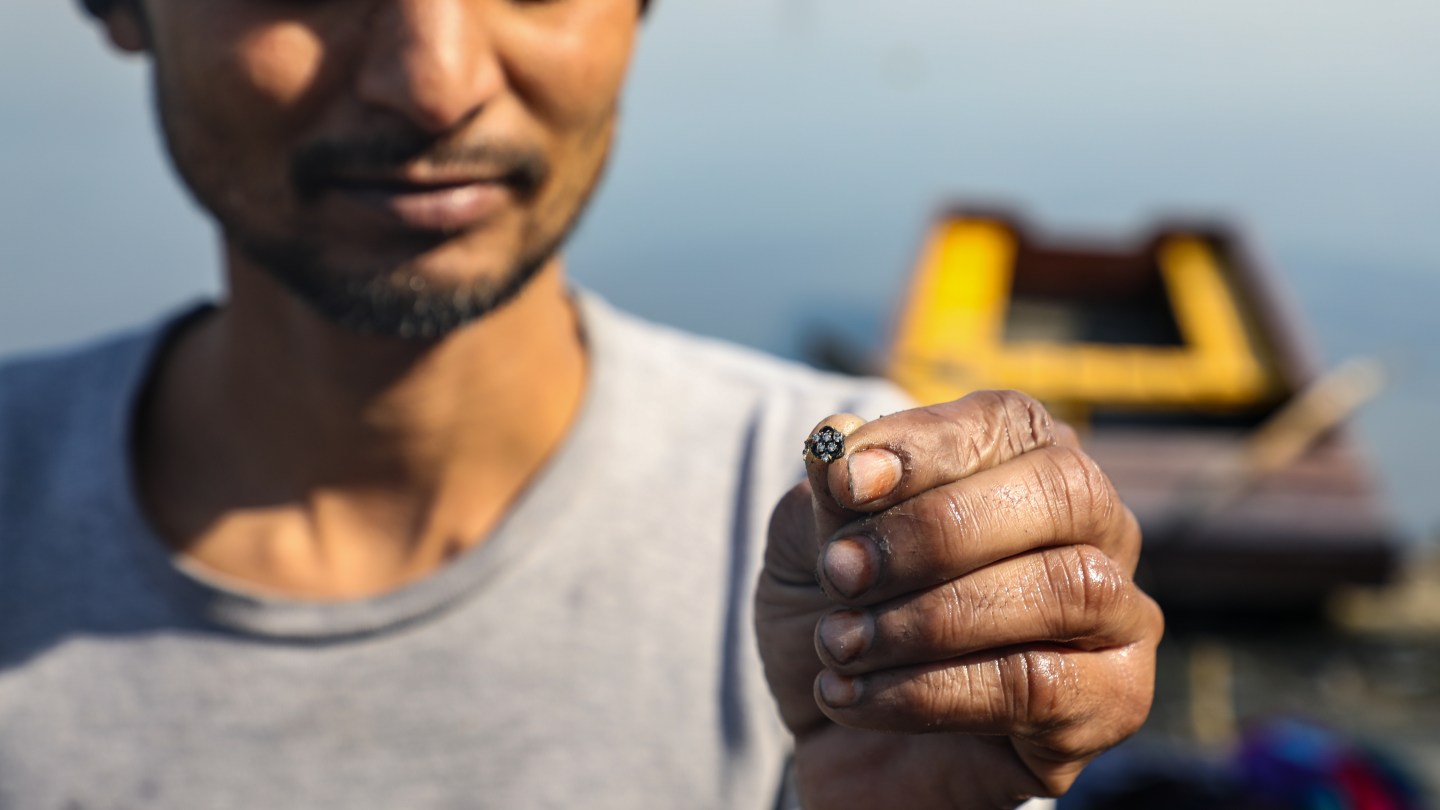 Mental shows off a nose ring he found during one of his dives.