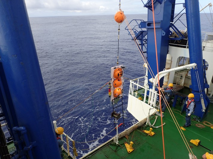 a hydrophone is deployed off the side of a ship into the deep sea