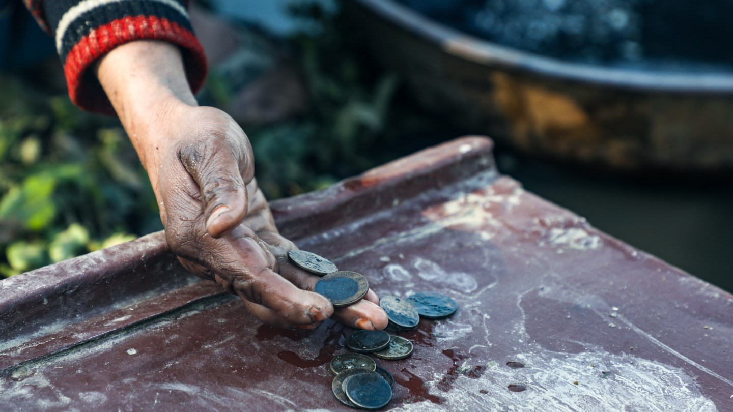 A diver shows off coins that he retrieved from the river.
