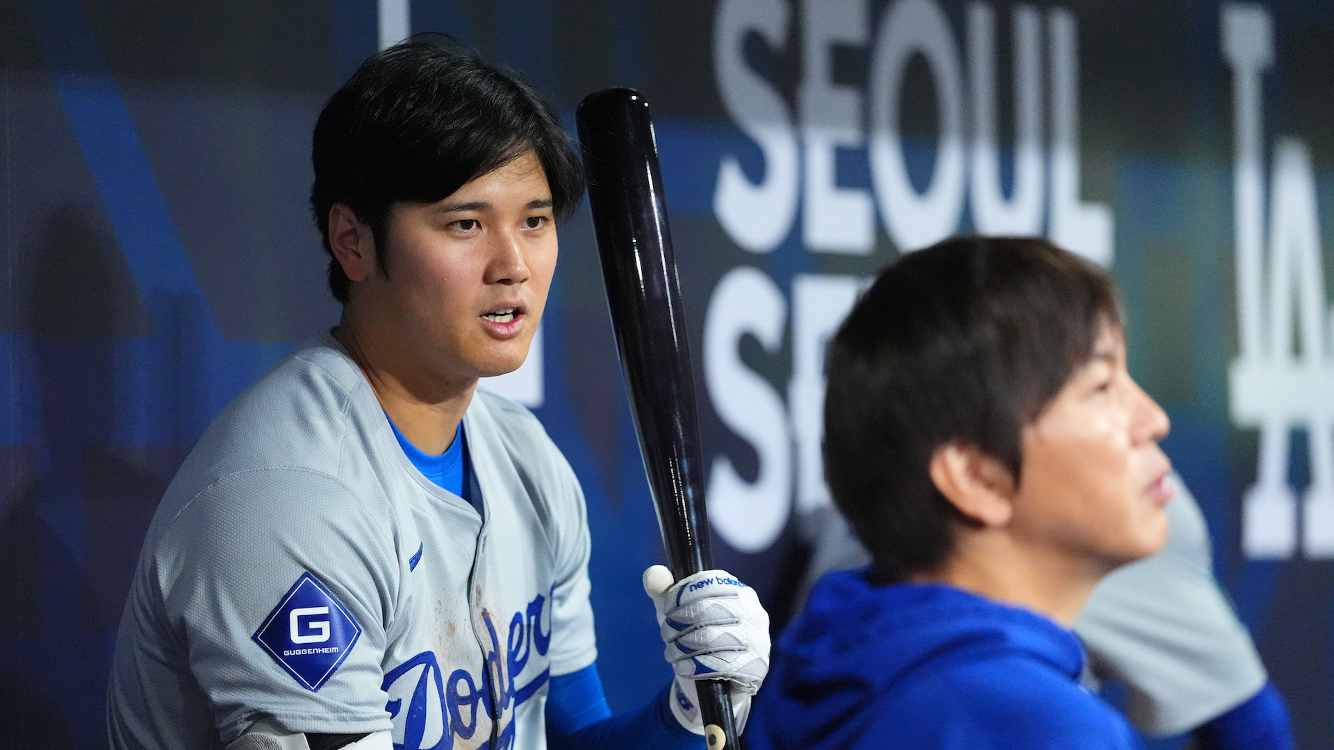 Shohei Ohtani #17 of the Los Angeles Dodgers talks to his interpreter Ippei Mizuhara in the dugout during the 2024 Seoul Series game between Los Angeles Dodgers and San Diego Padres.