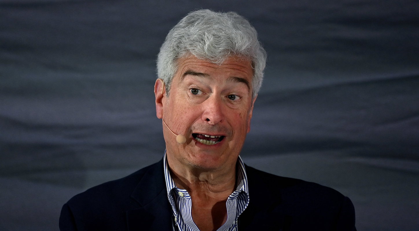 G/O Media CEO Jim Spanfeller speaking at a conference with one of those microphones you wear on your ear.