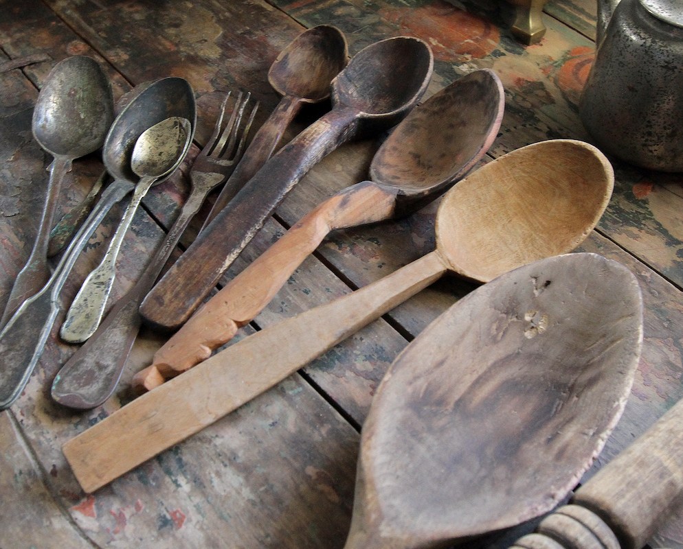 Wooden and iron spoons lie on the table at the folk museum, Kovpakivka village, Mahdalynivka district, Dnipropetrovsk Region, central Ukraine.