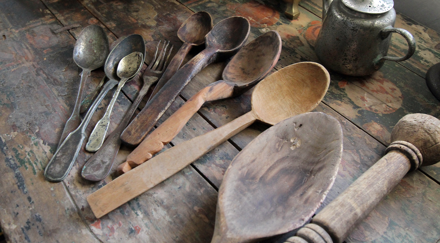 Wooden and iron spoons lie on the table at the folk museum, Kovpakivka village, Mahdalynivka district, Dnipropetrovsk Region, central Ukraine.