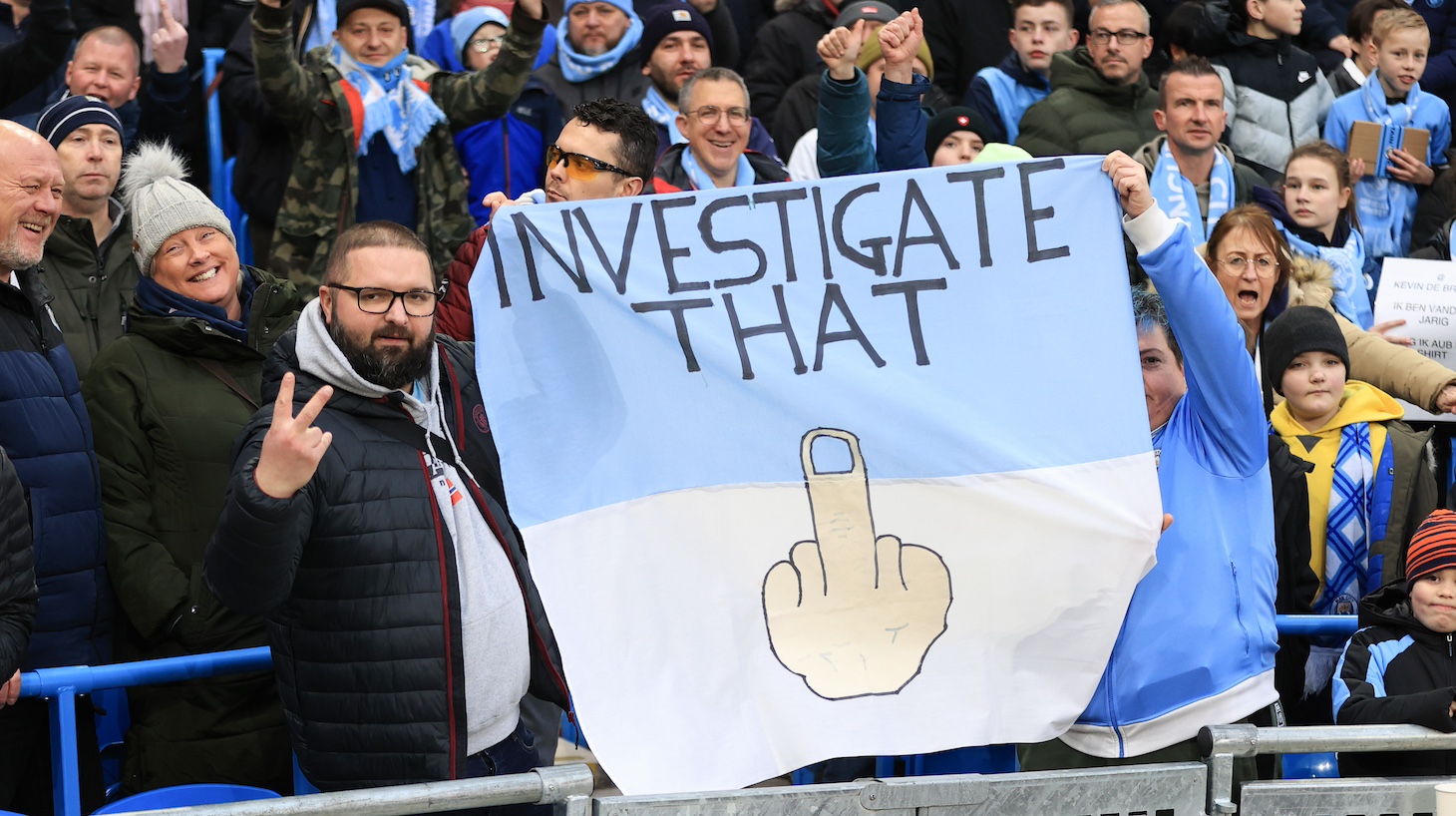 Manchester City fans hold up a sign in protest of the charges brought against the club due to financial fair play during the Premier League match between Manchester City and Aston Villa at Etihad Stadium on February 12, 2023 in Manchester, United Kingdom.