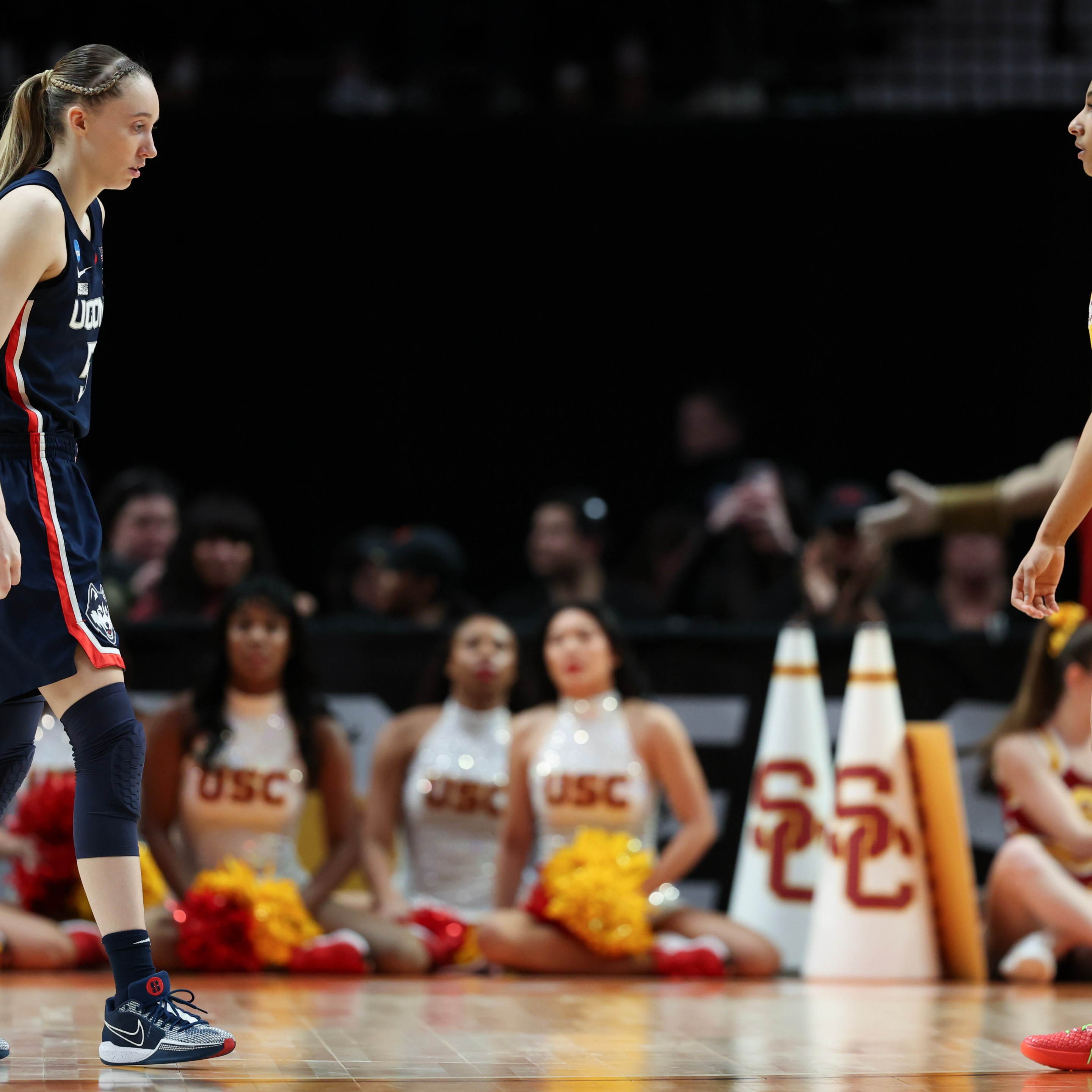 Paige Bueckers #5 of the Connecticut Huskies and JuJu Watkins #12 of the USC Trojans looks on during the second half in the Elite 8 round of the NCAA Women's Basketball Tournament at Moda Center on April 01, 2024 in Portland, Oregon.