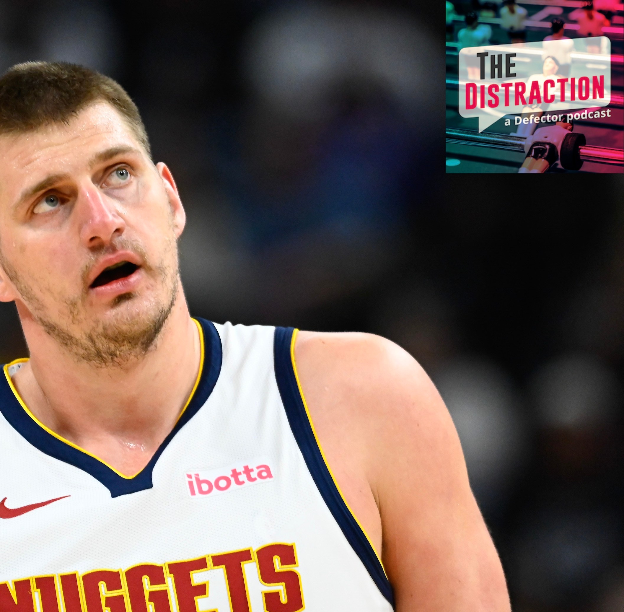 Nikola Jokic #15 of the Denver Nuggets looks on during the first half against the Utah Jazz at Delta Center on April 9, 2024. I put the little Distraction logo at upper right so it looks like he's glowering at it.