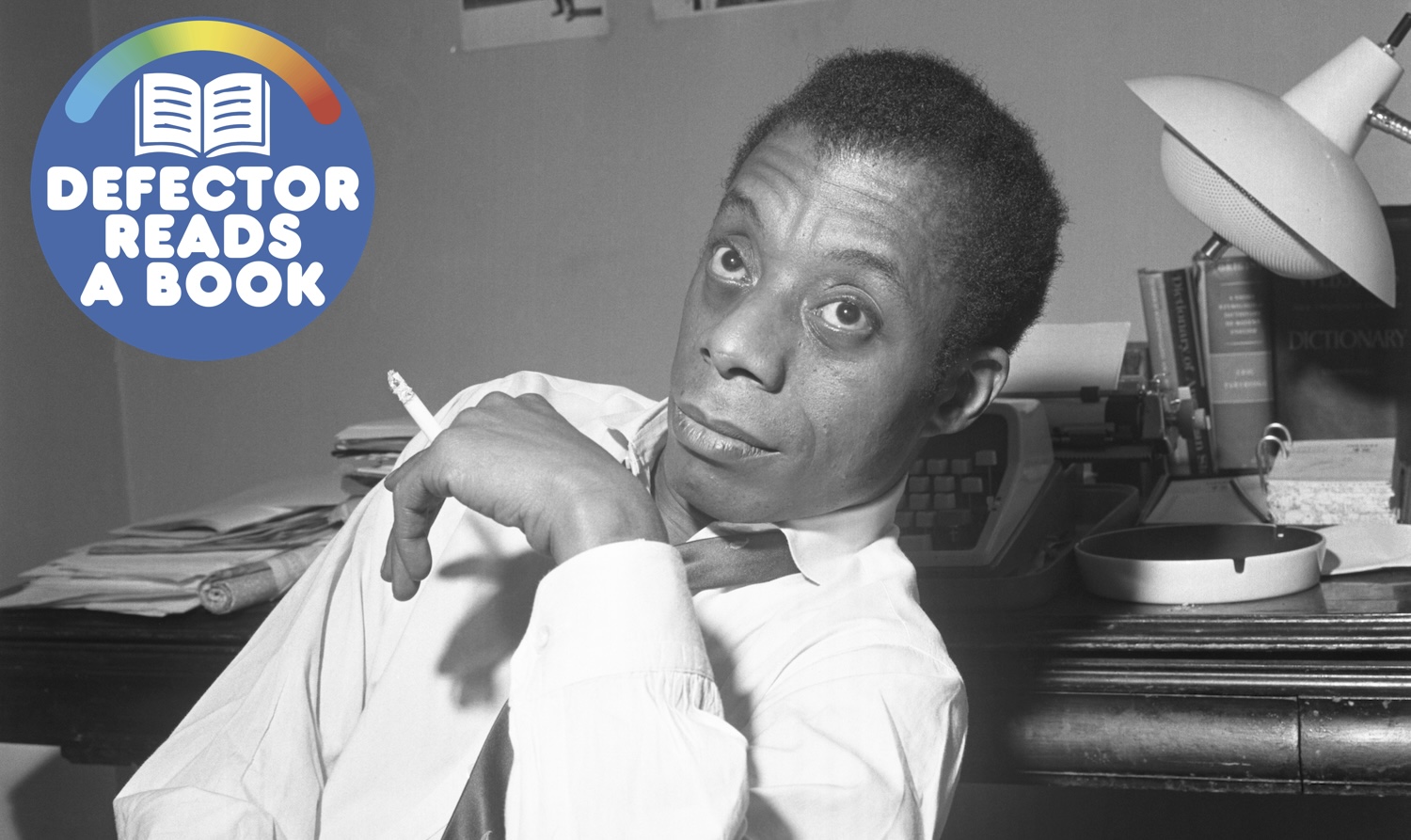 A photographer of author James Baldwin smoking a cigarette.