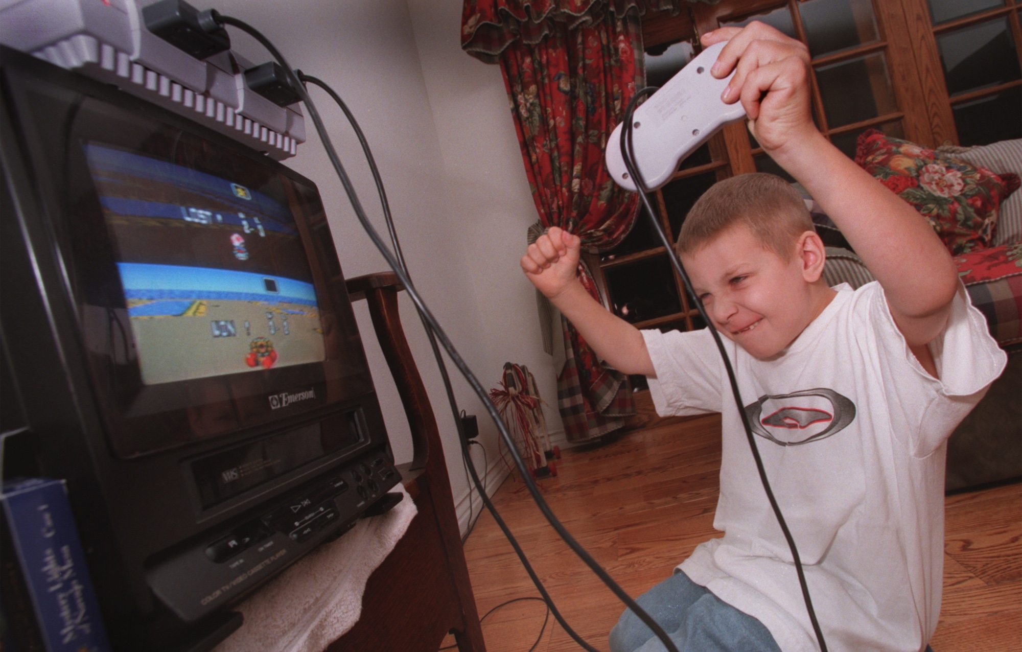 Billy Hale, age 7, Simi Valley celebrates a Nintendo victory over his brother. Photo/Art by:Alan Hagman
