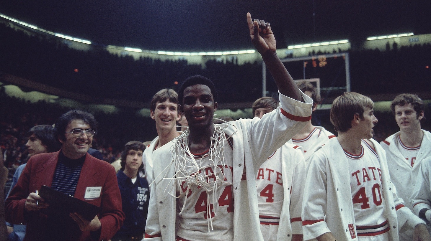College Basketball: NCAA Final Four, North Carolina State David Thompson (44) victorious with net after winning game vs UCLA, Greensboro, NC 3/24/1974