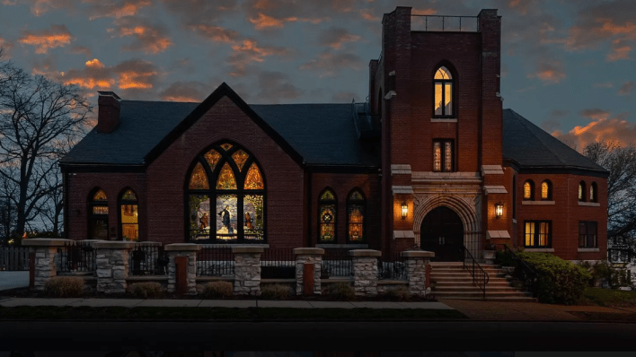 church at night wher eyou can see the stained glass glow