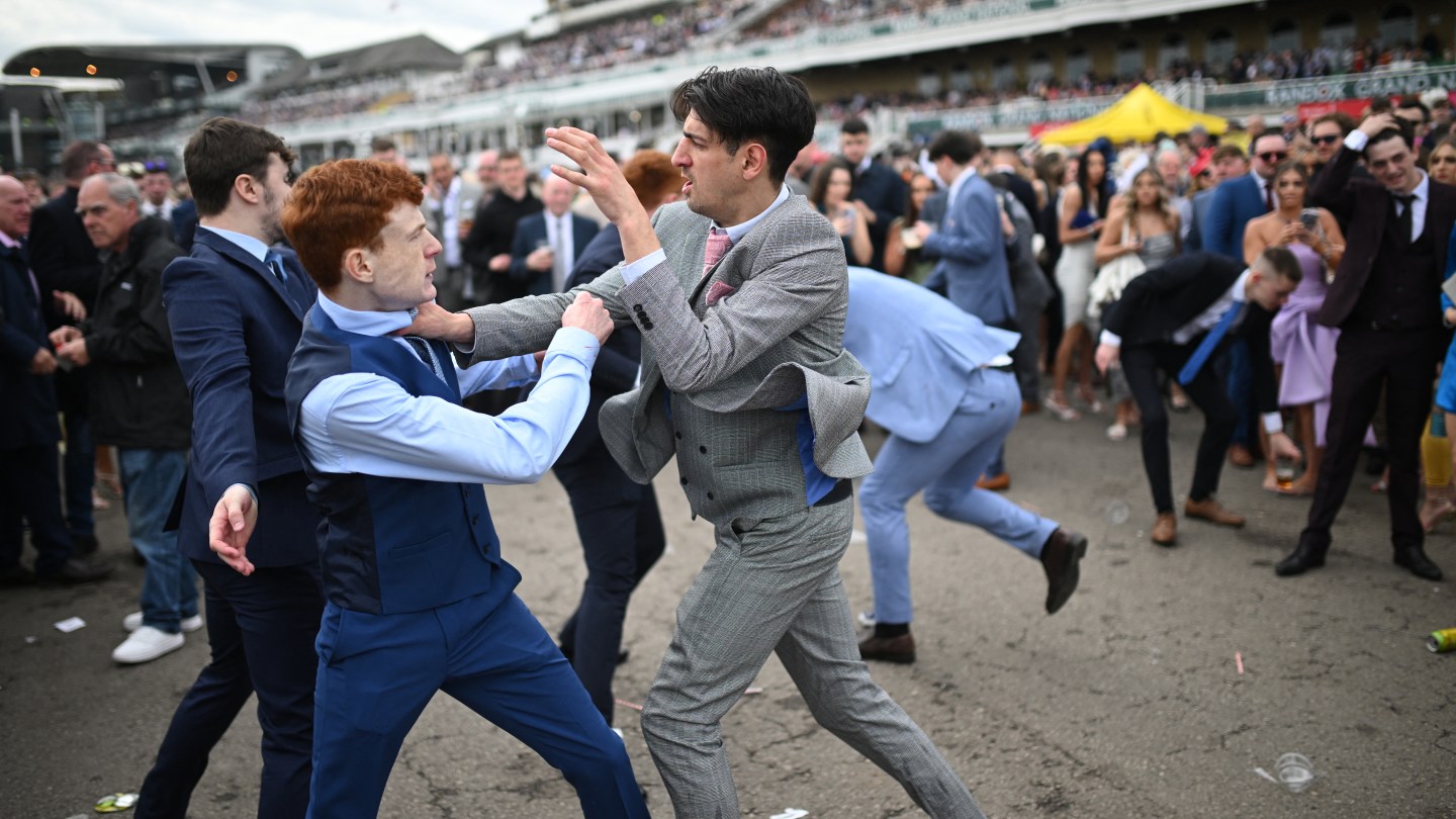 Racegoers fight each other as they scuffle on the second day of the Grand National Festival horse race meeting at Aintree Racecourse in Liverpool, north-west England, on April 12, 2024.