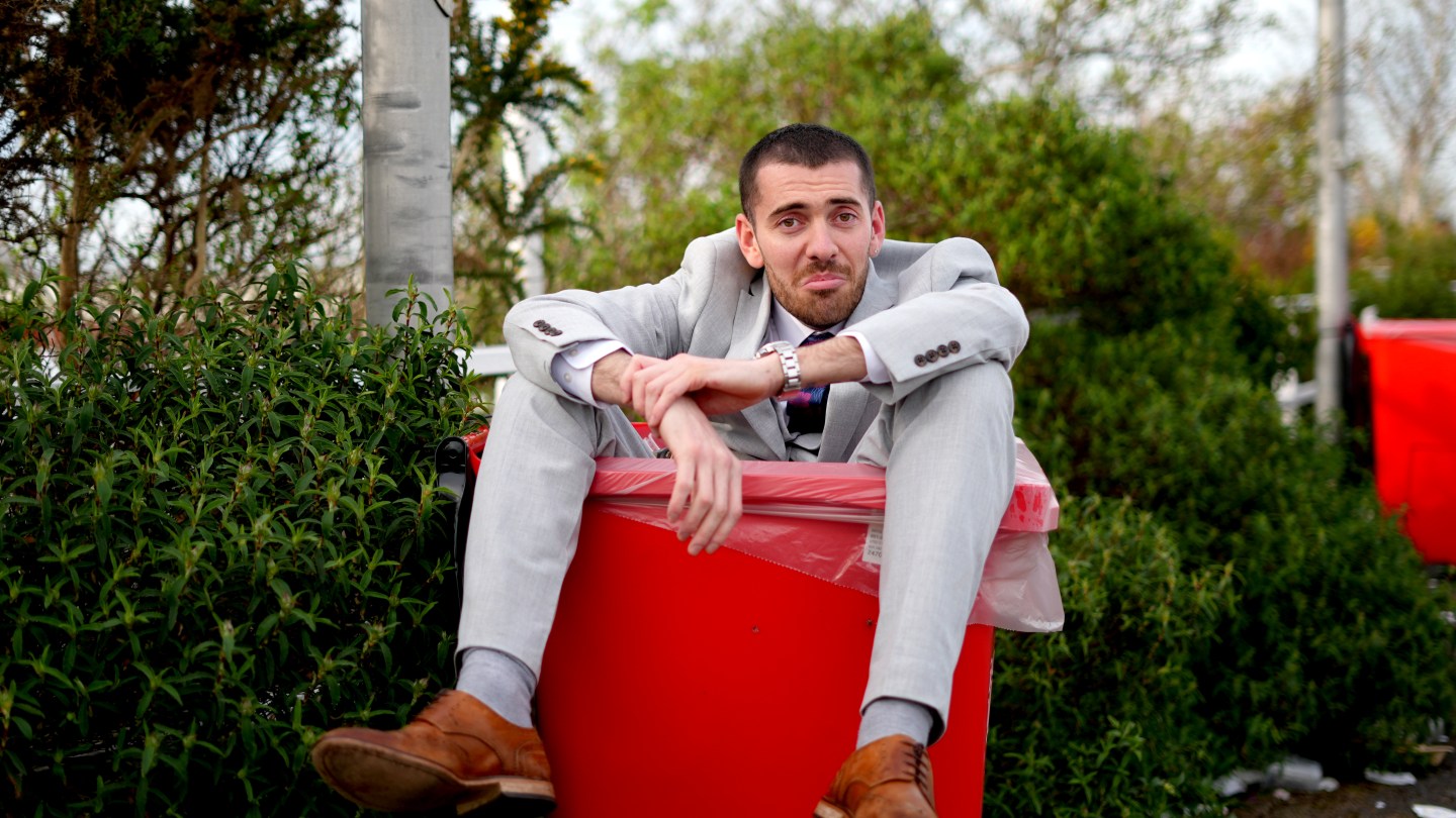 A racegoer sits in a bin at the end of day two of the 2024 Randox Grand National Festival at Aintree Racecourse, Liverpool.