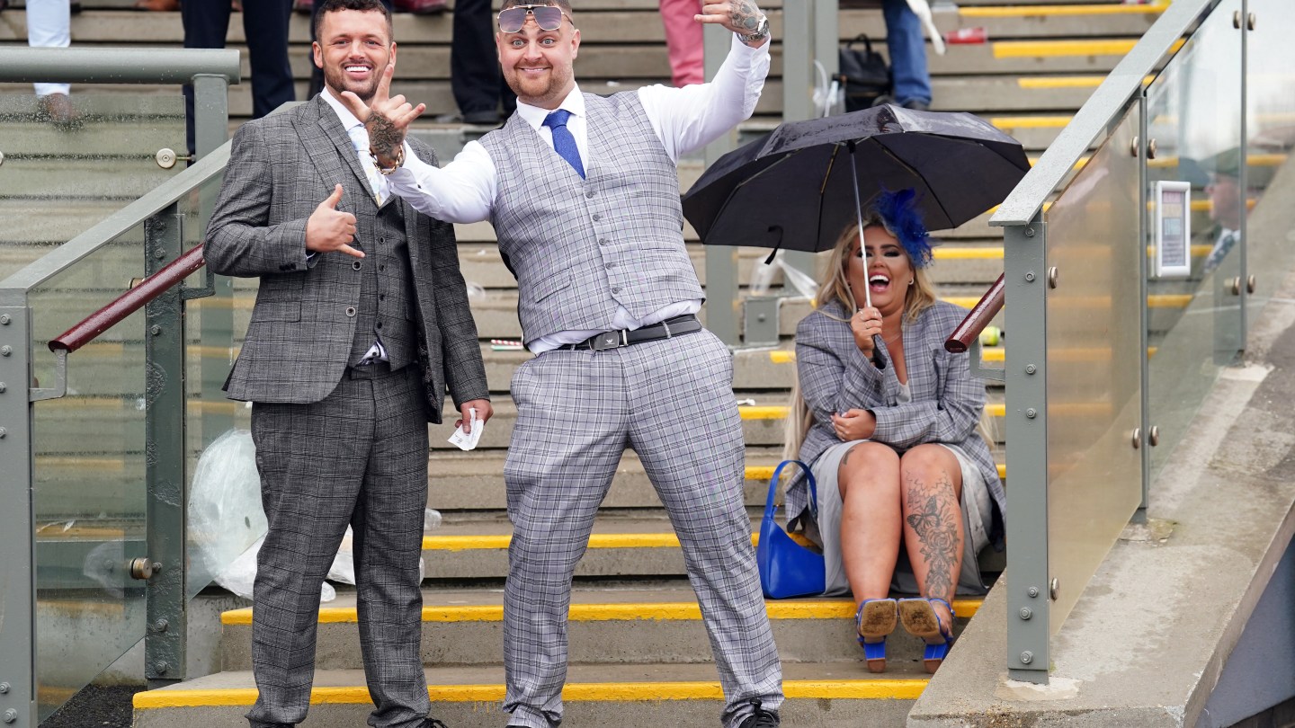 Racegoers enjoy themselves whilst taking shelter from the rain on day three of the 2024 Randox Grand National Festival at Aintree Racecourse, Liverpool.