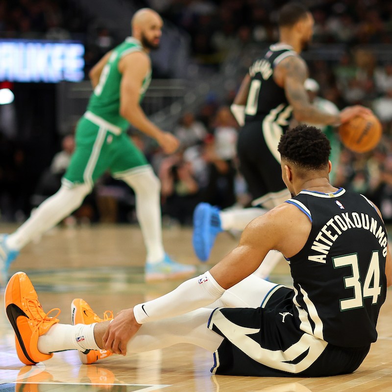 Giannis Antetokounmpo #34 of the Milwaukee Bucks sits injured on the court during the second half of a game against the Boston Celtics on April 09, 2024 in Milwaukee, Wisconsin.