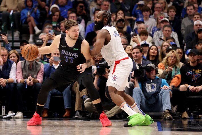 James Harden #1 of the LA Clippers guards Luka Doncic #77 of the Dallas Mavericks in the second half on December 20, 2023 in Dallas, Texas.