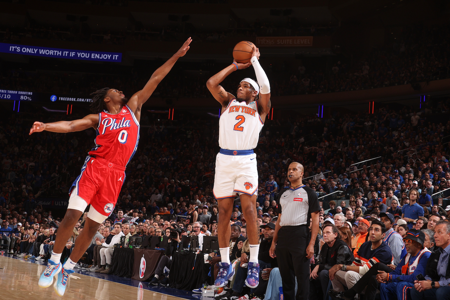 Deuce McBride of the New York Knicks rises up to shoot over Tyrese Maxey of the Philadelphia 76ers.