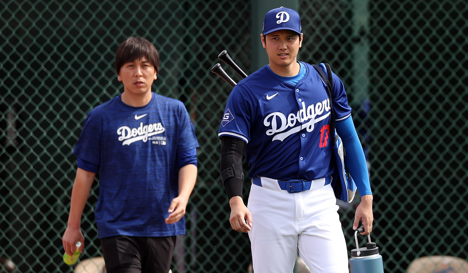 Shohei Ohtani #17 of the Los Angeles Dodgers, pictured with his translator, Ippei Mizuhara, prepares for a game against the Chicago White Sox at Camelback Ranch.