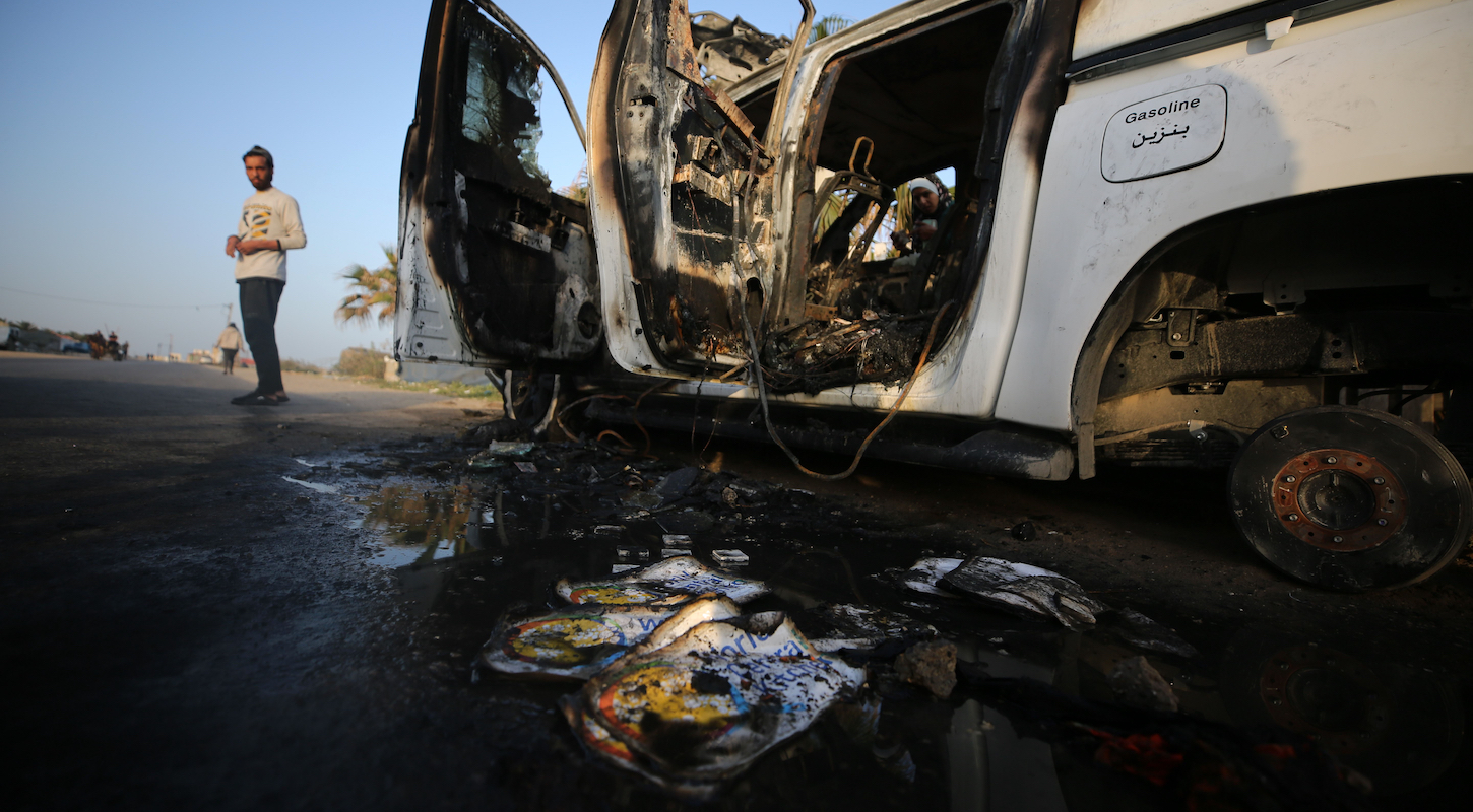 A Palestinian checks a damaged vehicle after Israeli strikes in central Gaza Strip city of Deir el-Balah, on April 2, 2024.