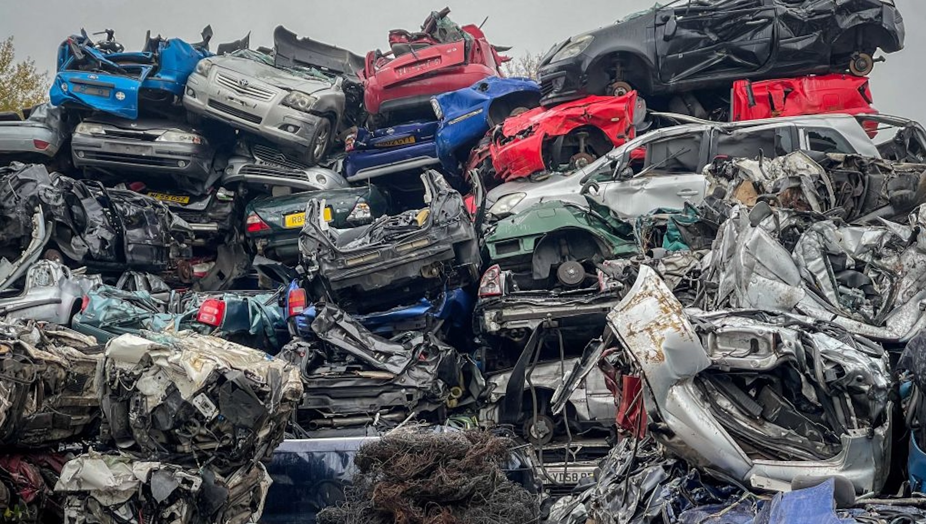 End of life petrol and diesel cars and vans are piled on top of one another as they wait to be recycled in a car scrapyard on November 29, 2022 in Glastonbury, England. The UK scraps over one million cars a year and many more petrol and diesel cars will need to be taken off the road if the Government is to reach its target for the number of electric cars to be reached.