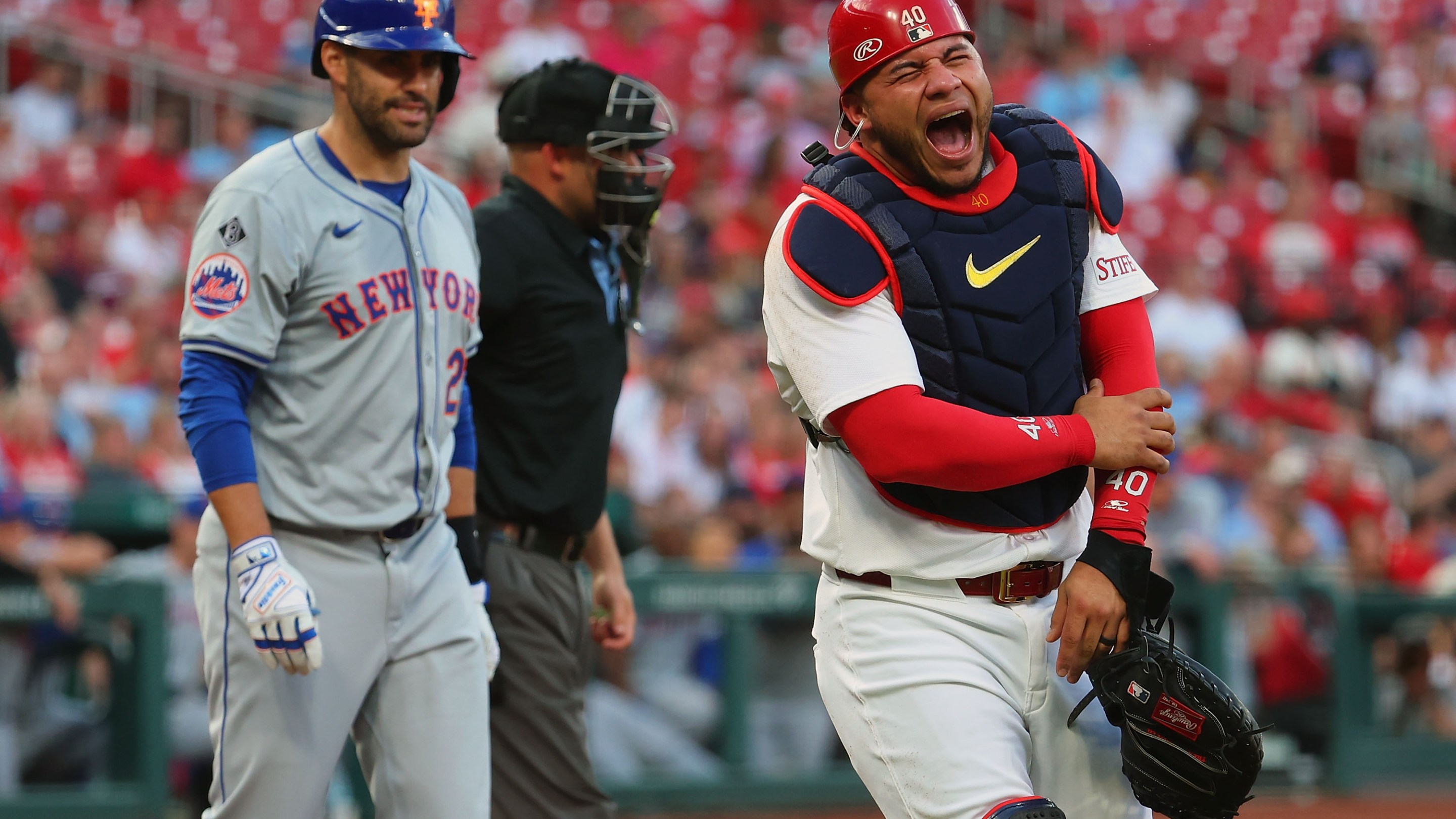 Willson Contreras of the St. Louis Cardinals reacts/screams after getting hit with a J.D. Martinez swing in a game on May 7, 2024.