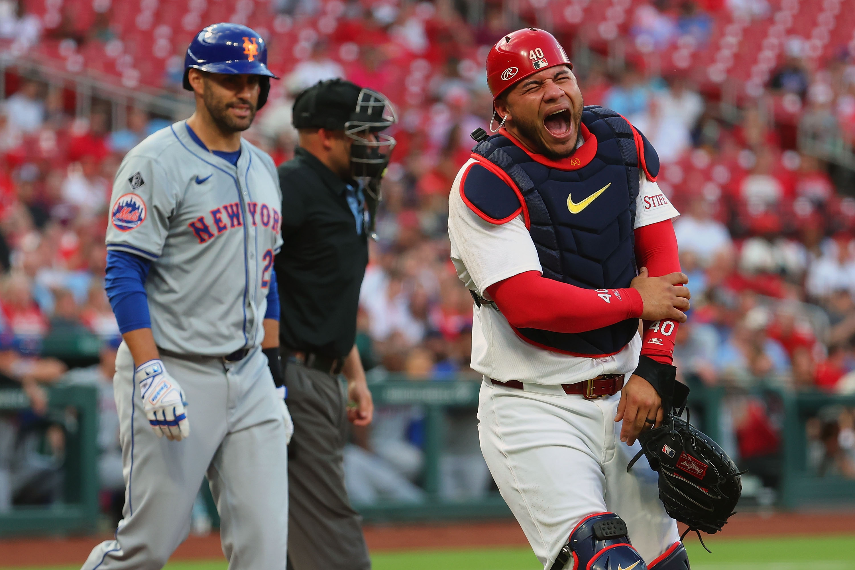 Willson Contreras of the St. Louis Cardinals reacts/screams after getting hit with a J.D. Martinez swing in a game on May 7, 2024.