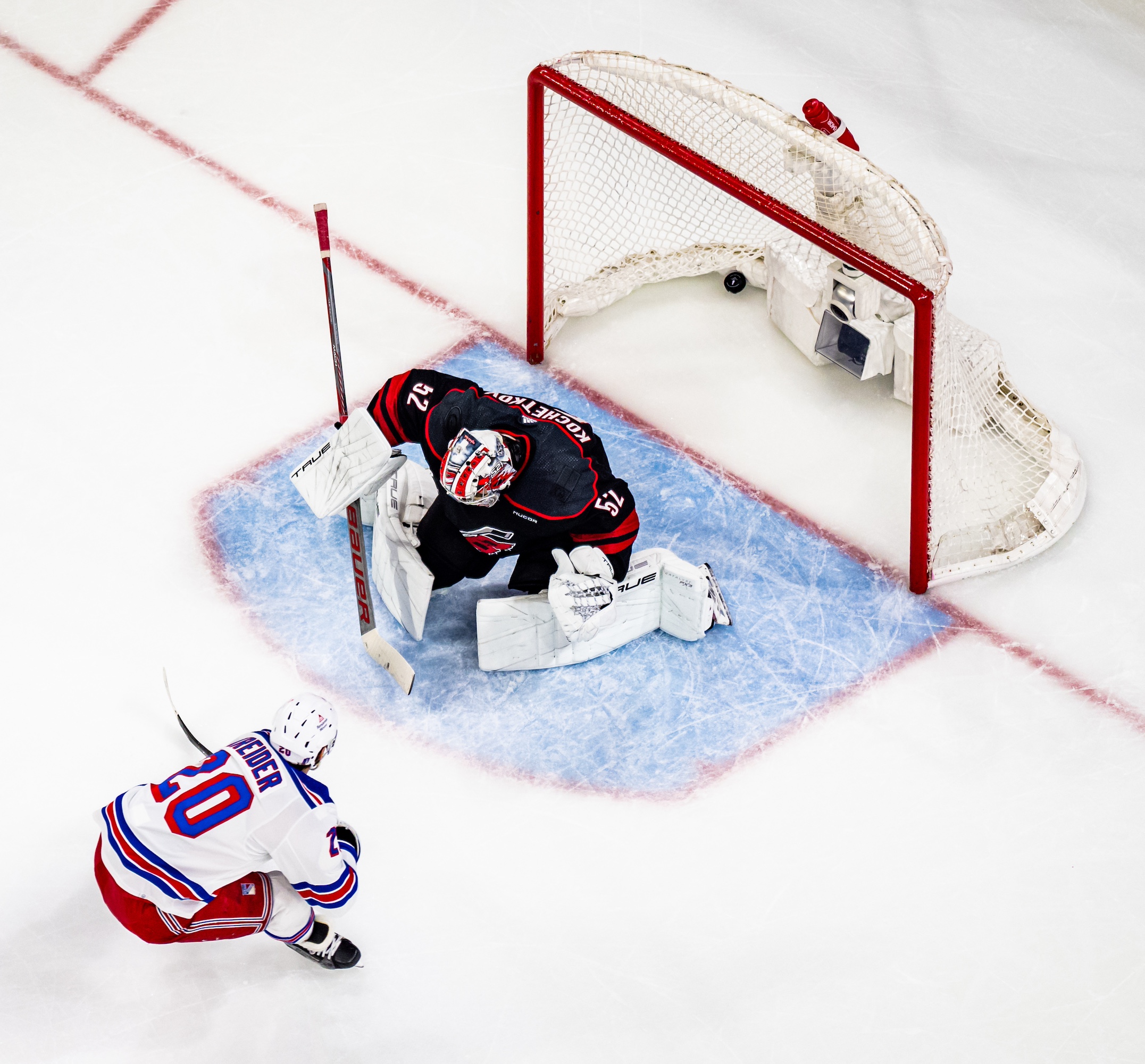 RALEIGH, NORTH CAROLINA - MAY 09: Chris Kreider #20 of the New York Rangers scores a goal against Pyotr Kochetkov #52 of the Carolina Hurricanes during the second period in Game Three of the Second Round of the 2024 Stanley Cup Playoffs at PNC Arena on May 09, 2024 in Raleigh, North Carolina. (Photo by Josh Lavallee/NHLI via Getty Images)